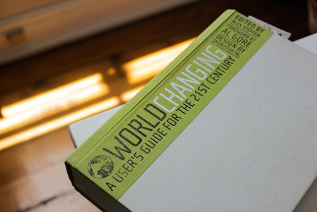 An illustrative photo of a book titled “World Changing” resting on a white table