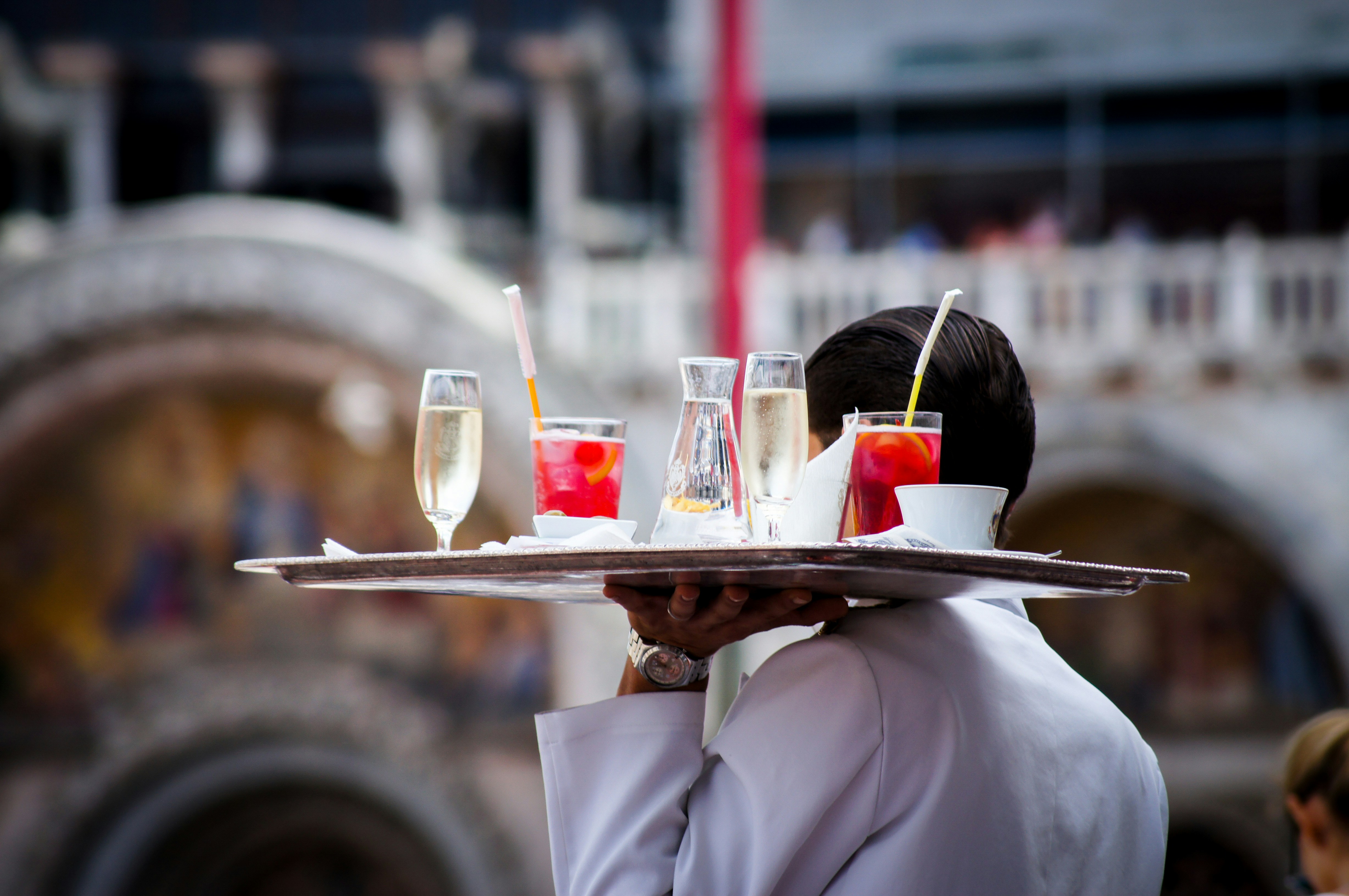 An illustrative photo of a waiter serving beverages