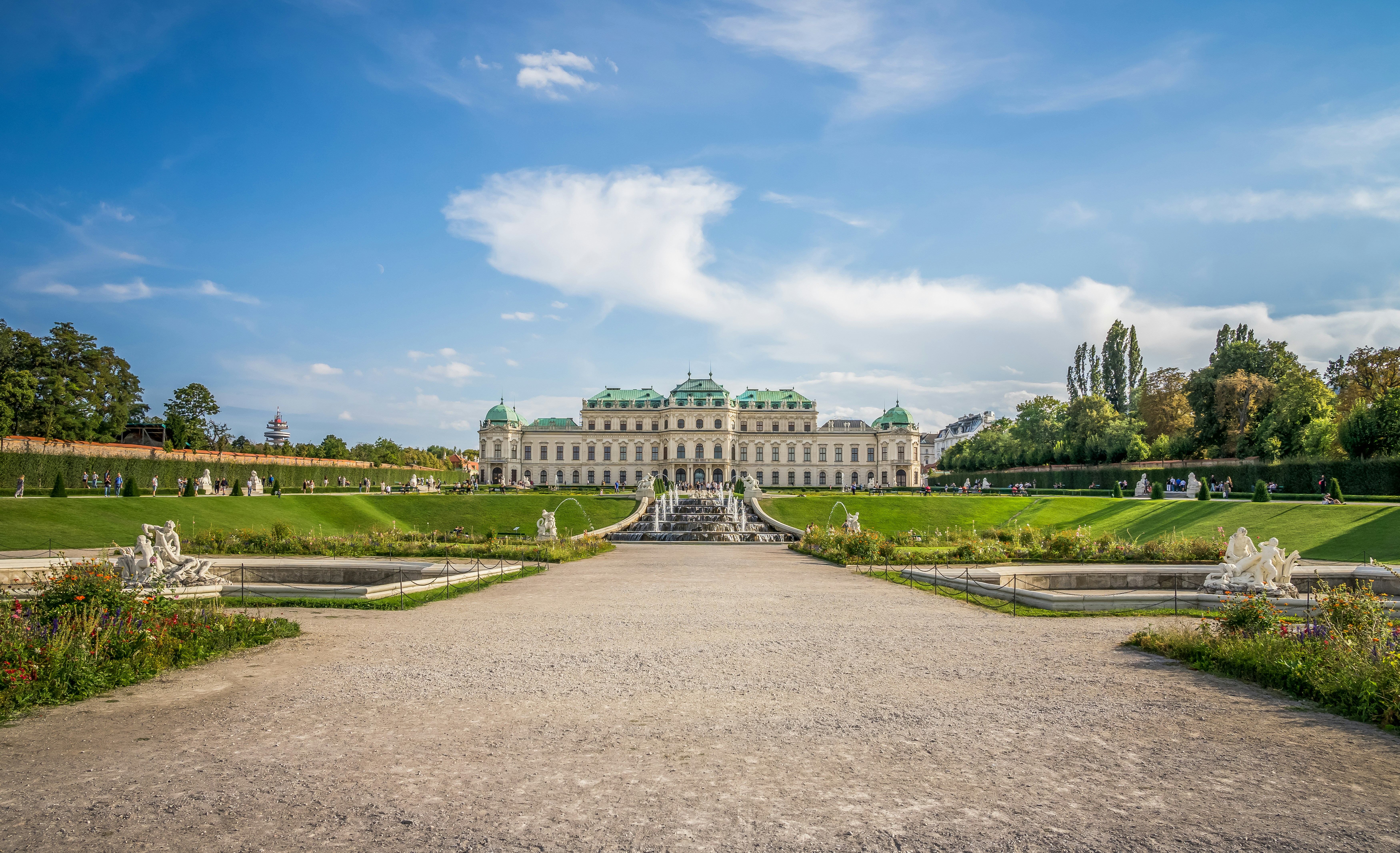 An illustrative photo of a large building with a fountain