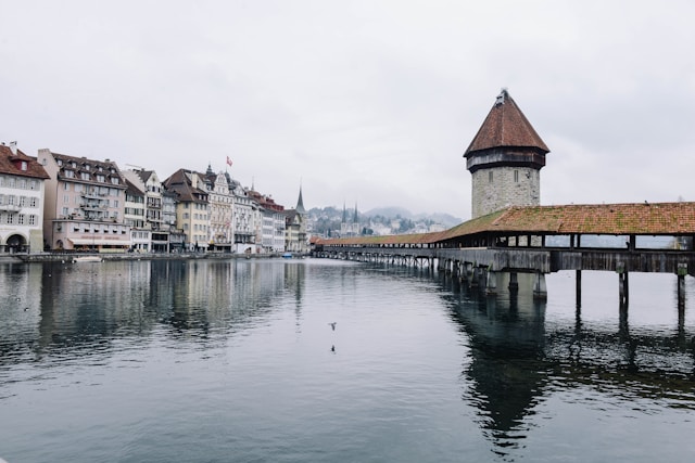 Photo by Unsplash An illustrative photo of body of water near concrete buildings under white and gray sky at daytime.