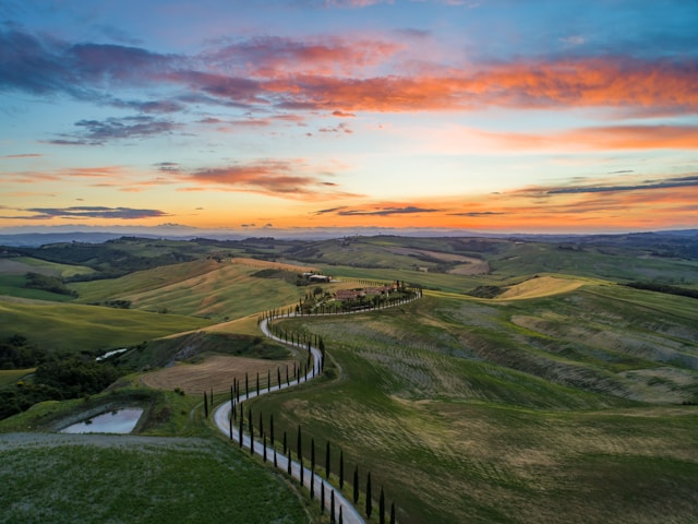 Photo by Unsplash An illustrative photo of a road between green grass field near mountains.