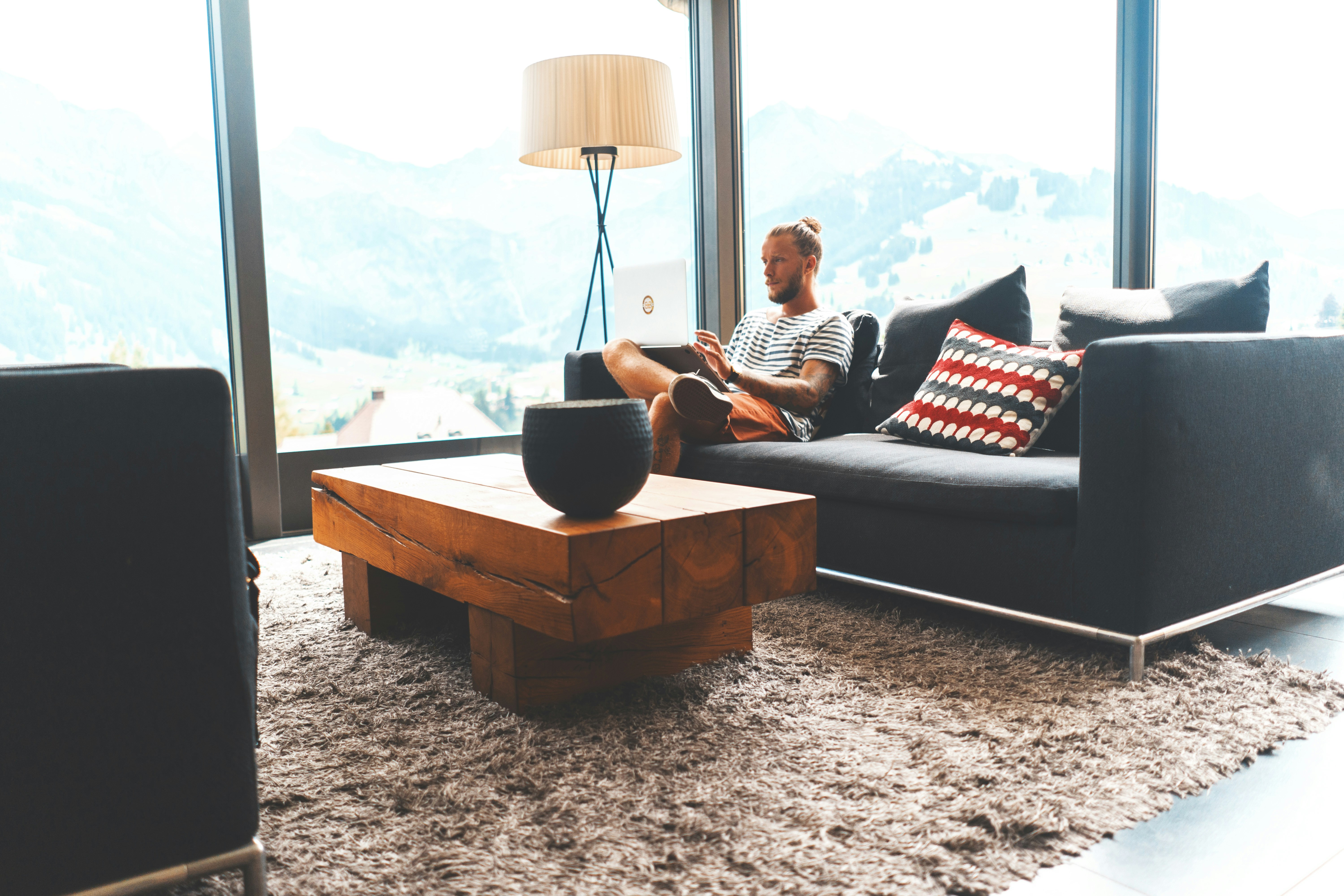 Photo by Unsplash An illustrative photo of a man sitting on sofa during daytime