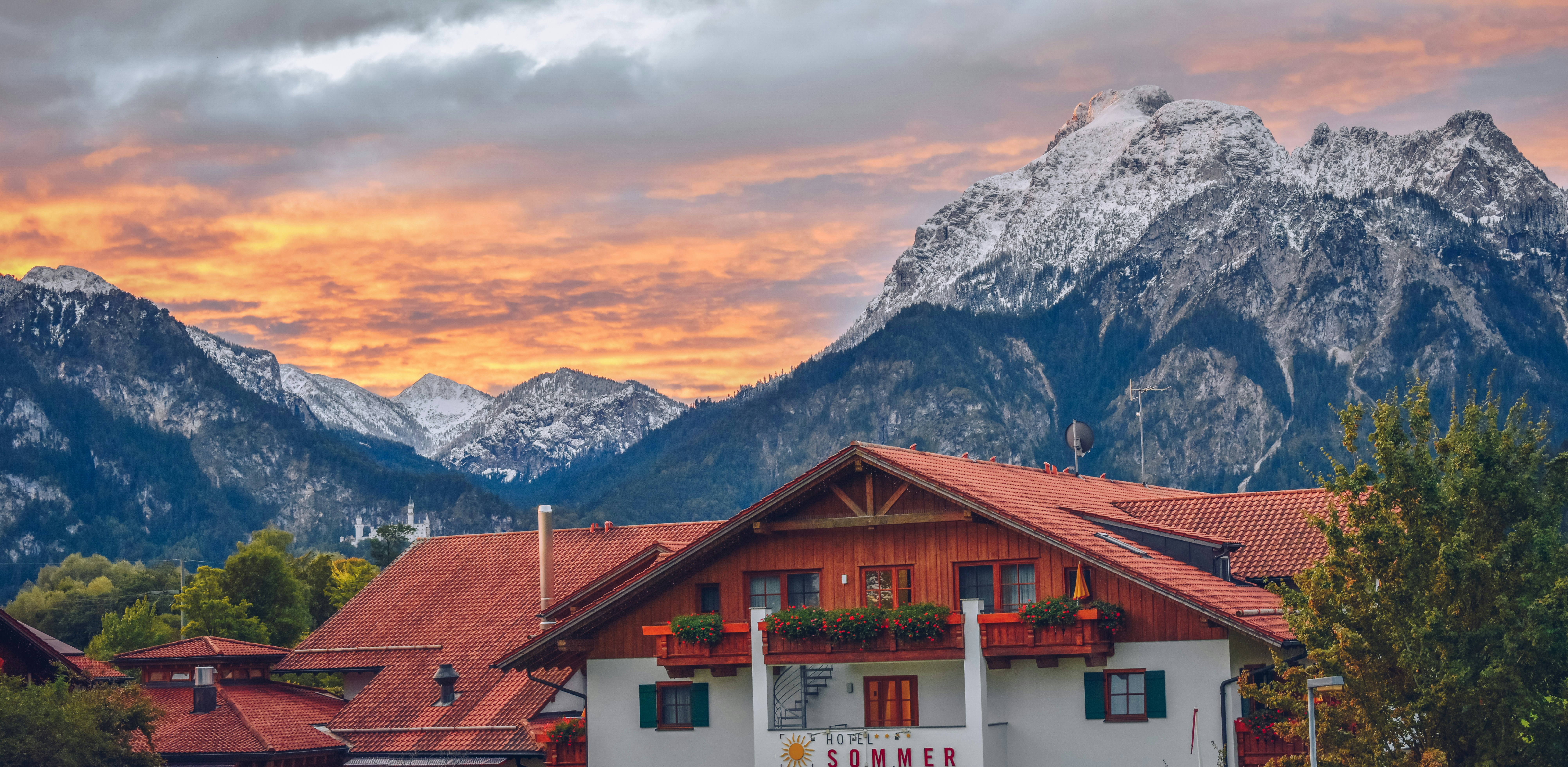 An illustrative photo of a house near snowy mountains.