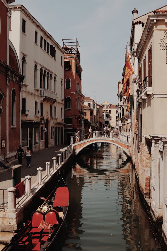 An illustrative photo of colorful buildings lining the canal and gondolas floating on the water