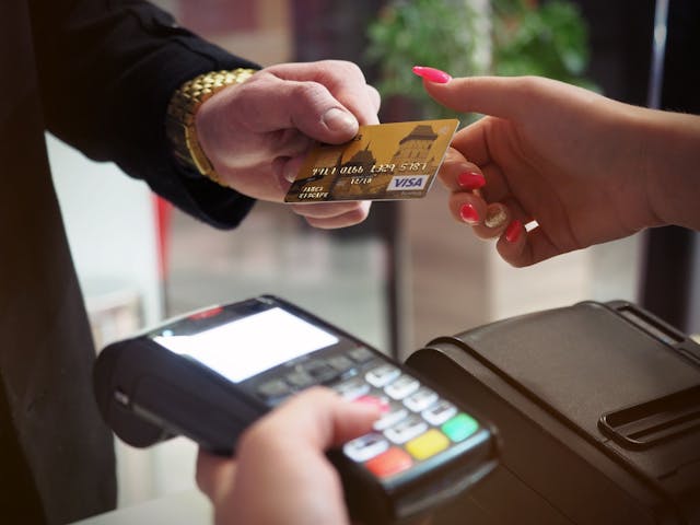 An illustrative photo of a sleek black payment terminal