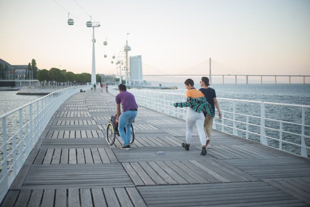 An illustrative photo of A group of people enjoy a peaceful walk on a bridge overlooking the sea