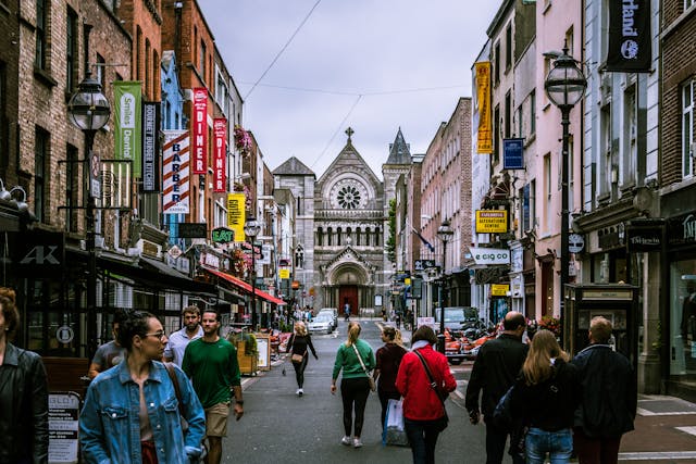 An illustrative photo of people walking along a bustling street