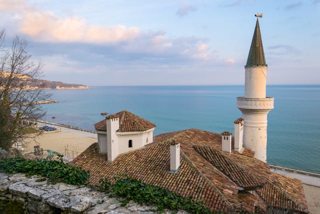 An illustrative photo of a white and brown building near the ocean