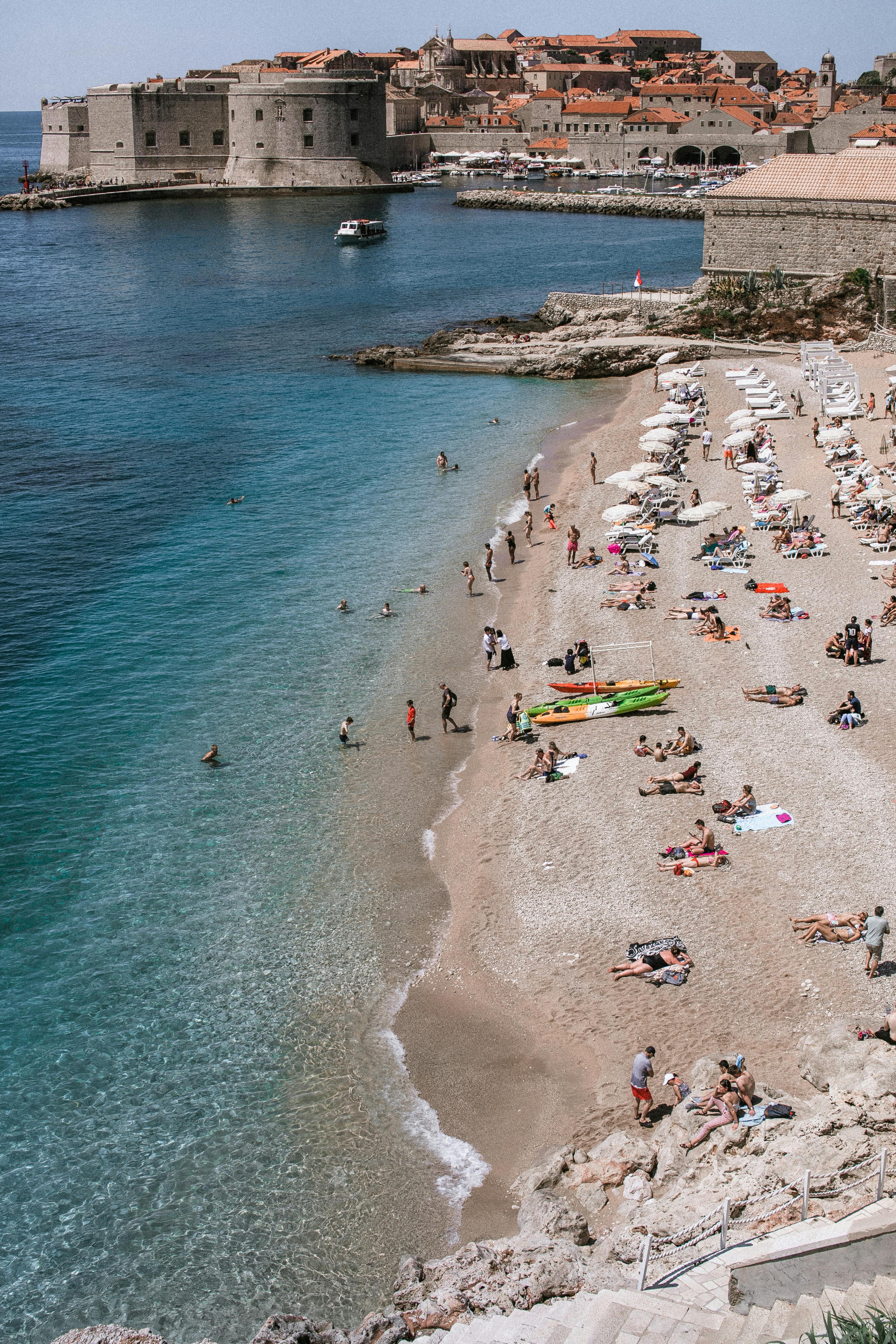 Photo by Pexels An illustrative photo of a beach scene with people sunbathing and swimming