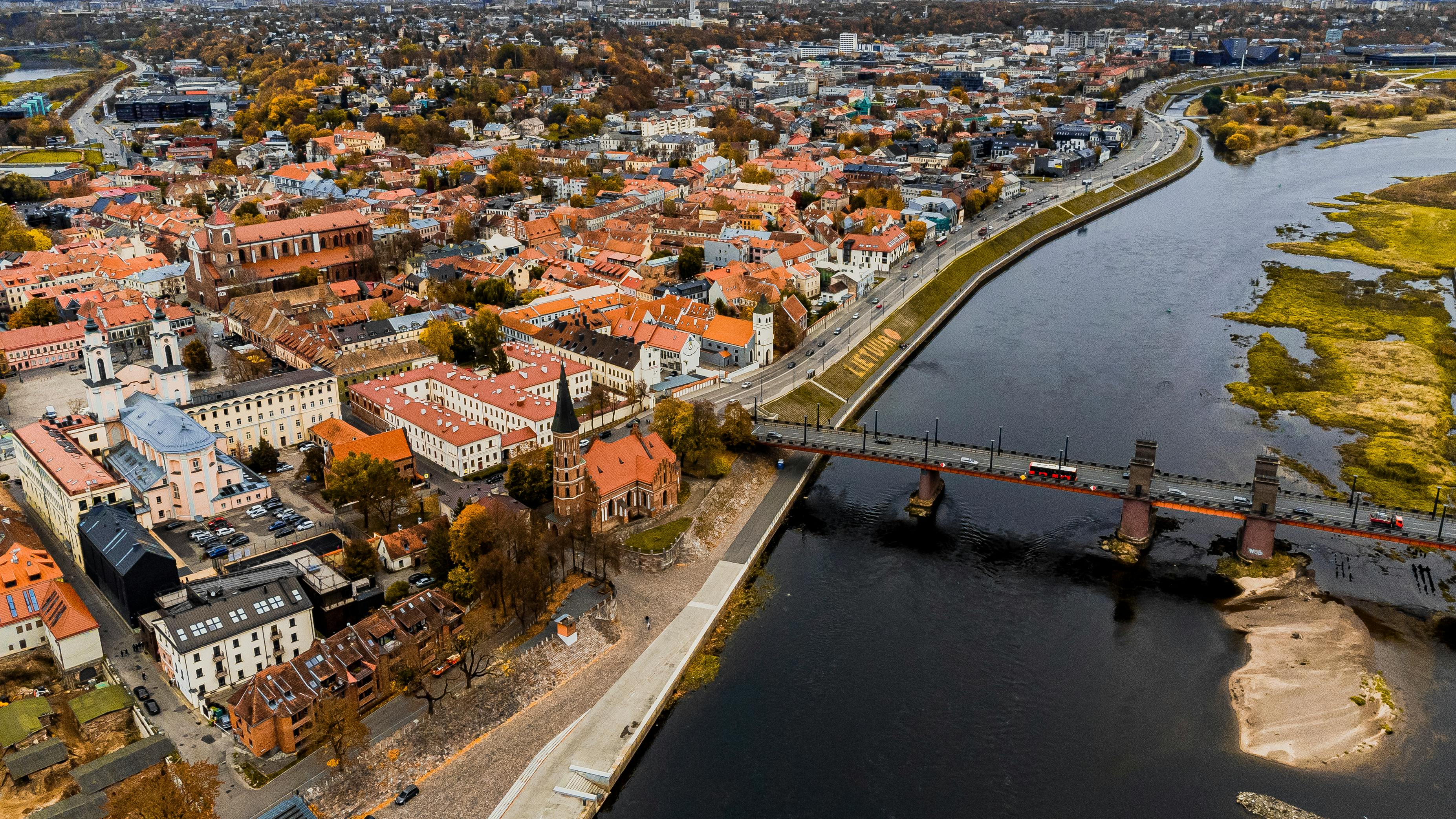 An illustrative photo of an aerial view of a historic city next to a river.