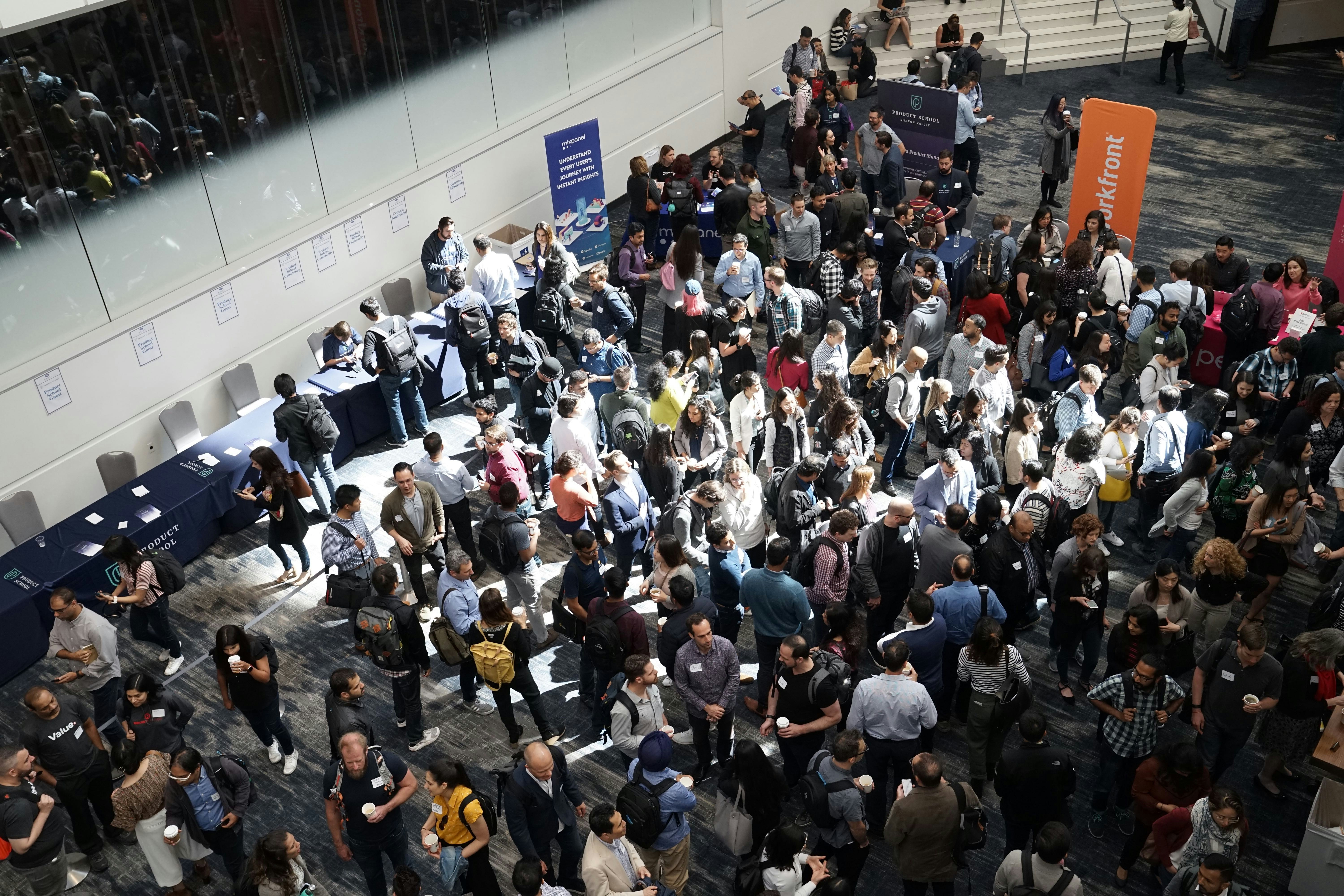 An illustrative photo of a crowd of people in building lobby