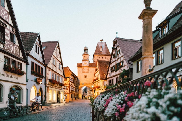 An illustrative photo of a charming European street scene at twilight.