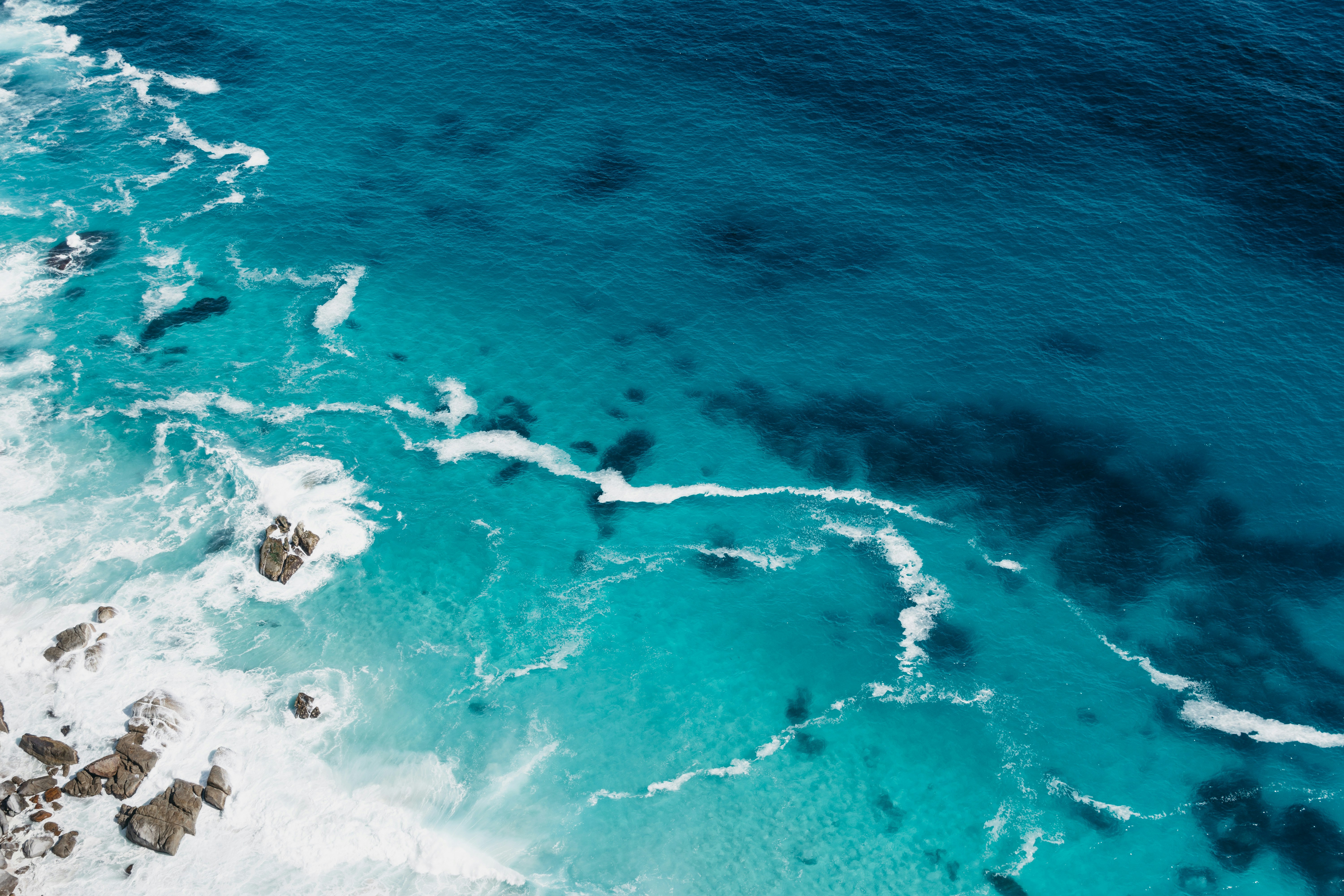 An illustrative photo of aerial view of seashore with stones