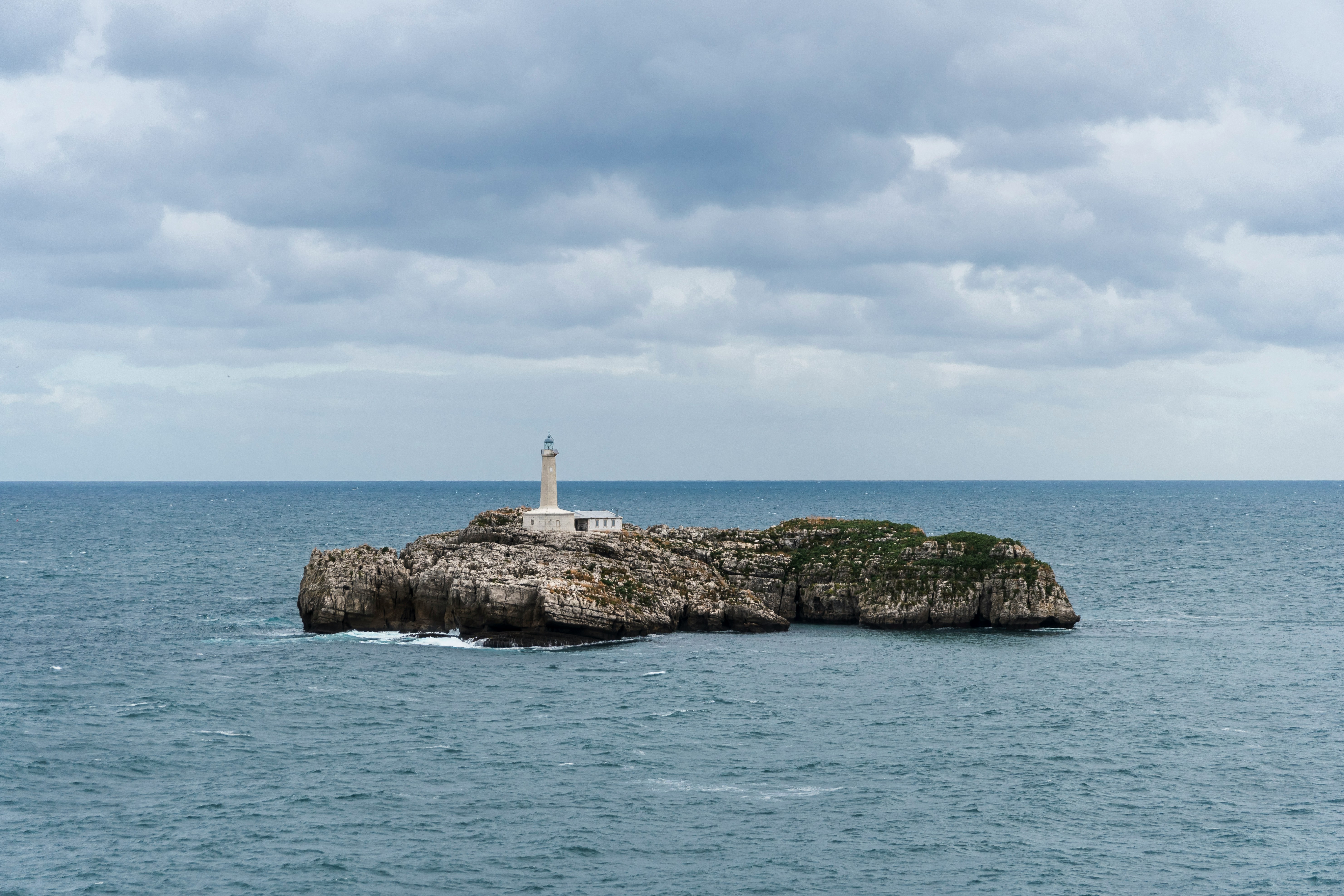 An illustrative photo of a lighthouse on islet in the ocean