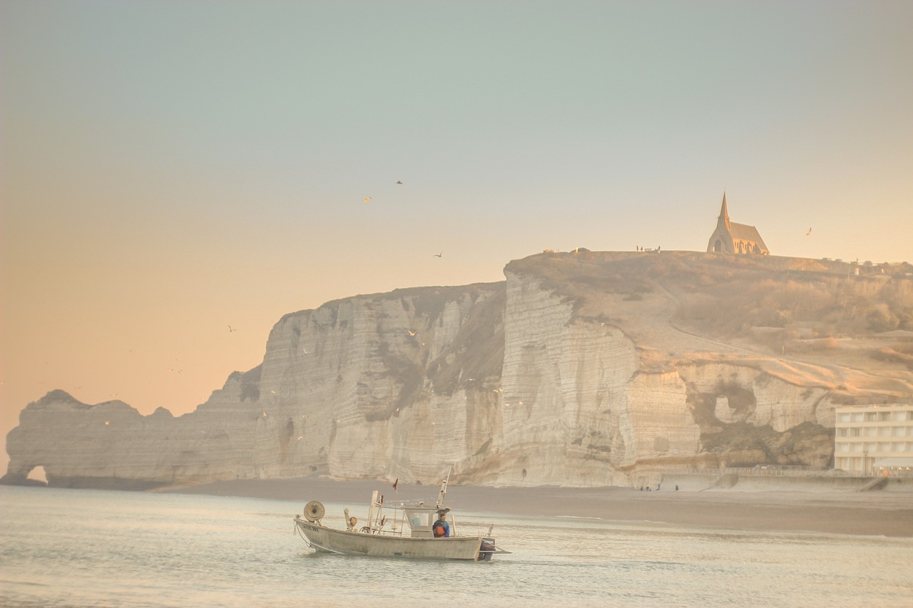 Photo by Pixabay An illustrative photo of a boat in the body of water with cliffs in the background during sunset
