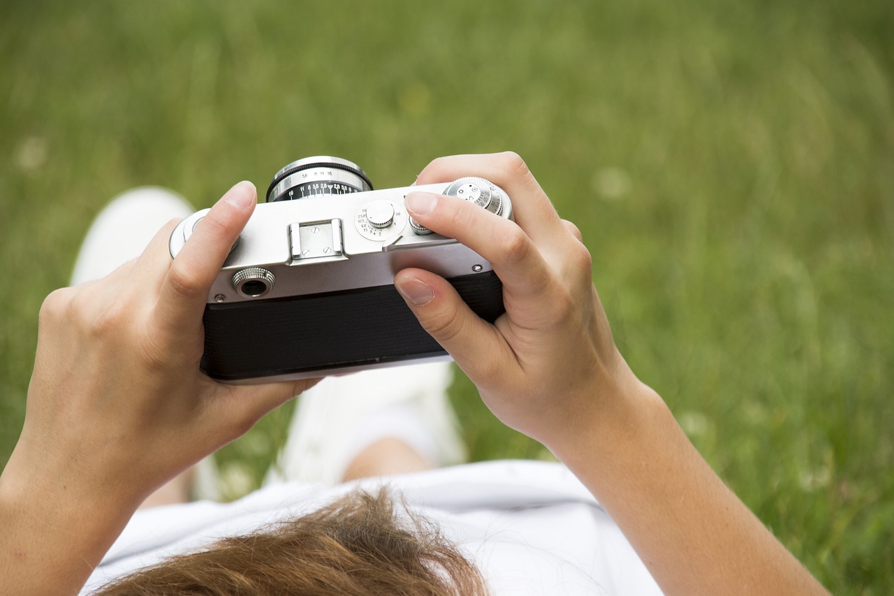 An illustrative photo of a person holding a retro camera
