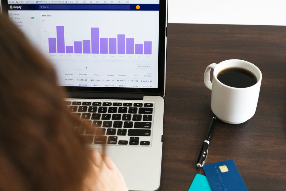 An illustrative photo of a person checking data on a laptop