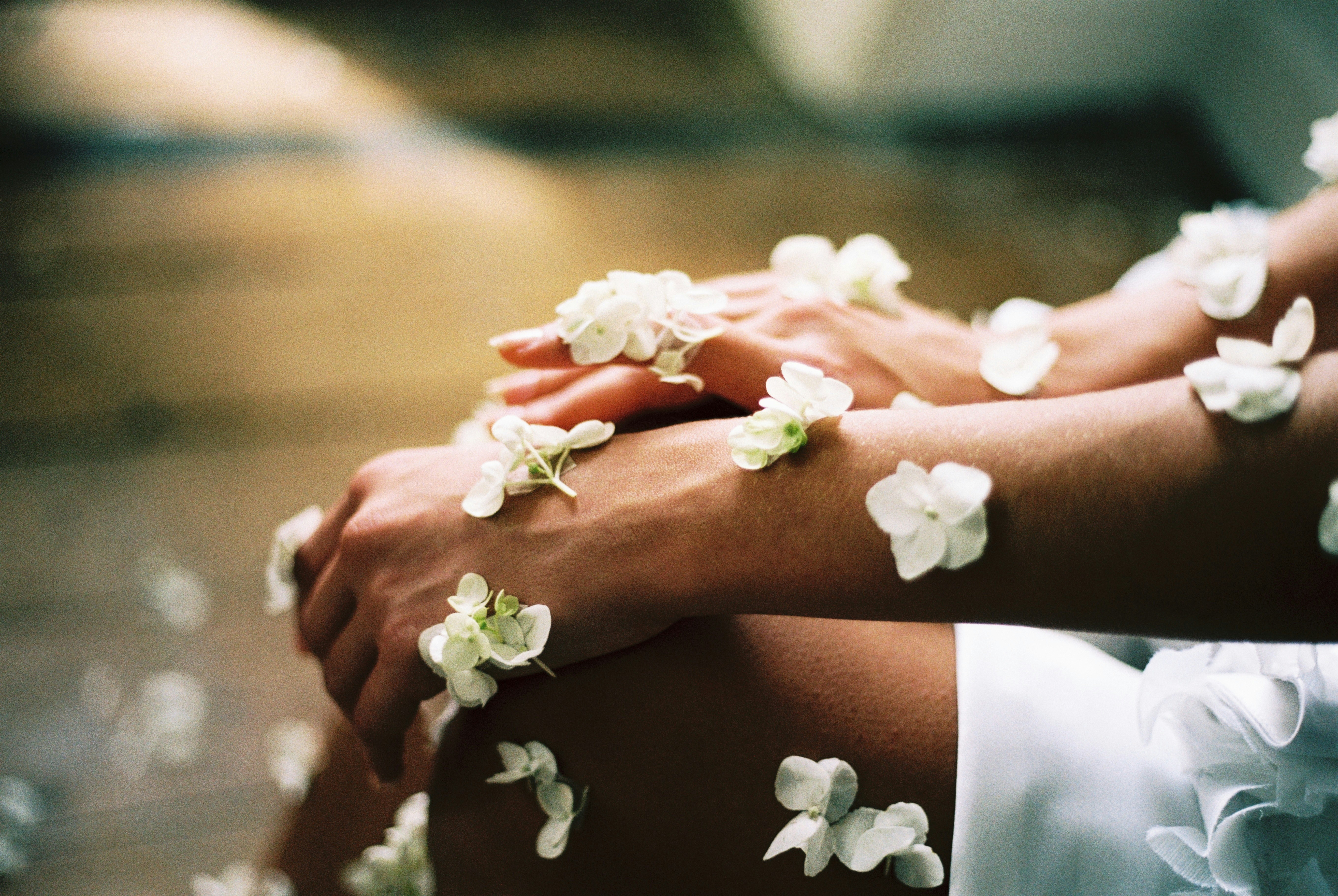 An illustrative photo of a person surrounded by white flowers.