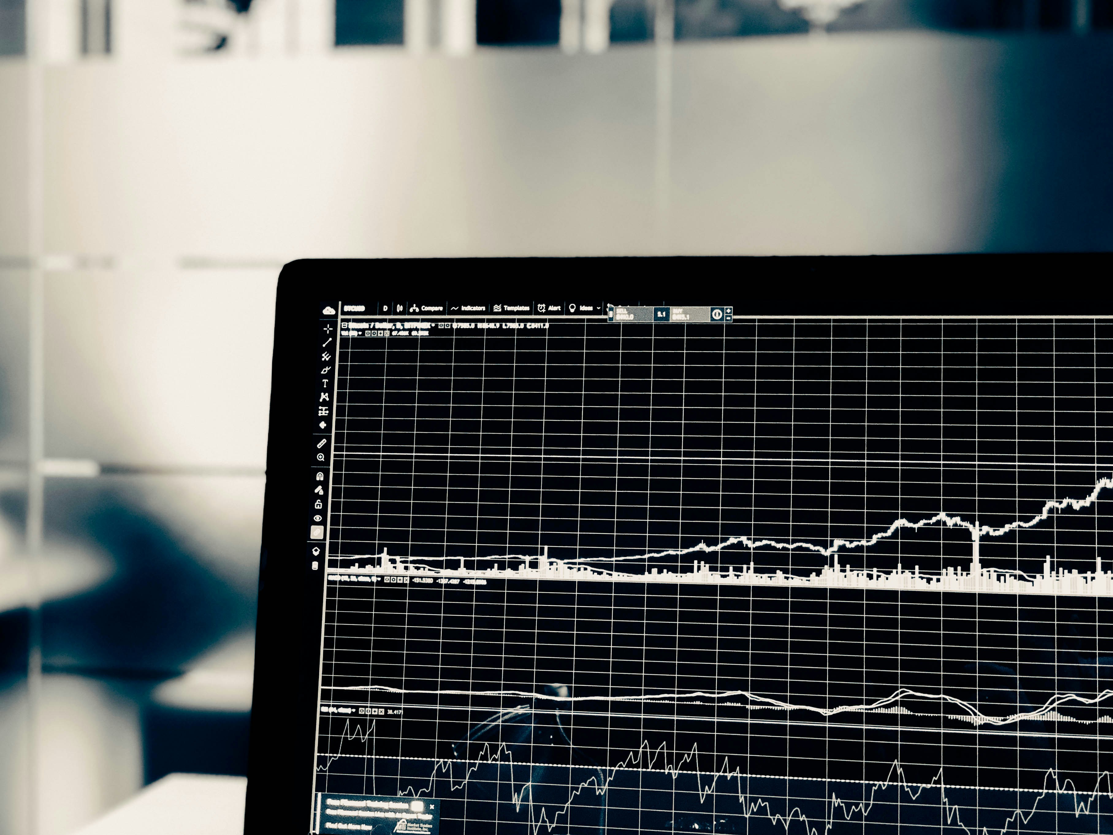 An illustrative photo of a close-up view of a computer monitor displaying a graph with multiple lines