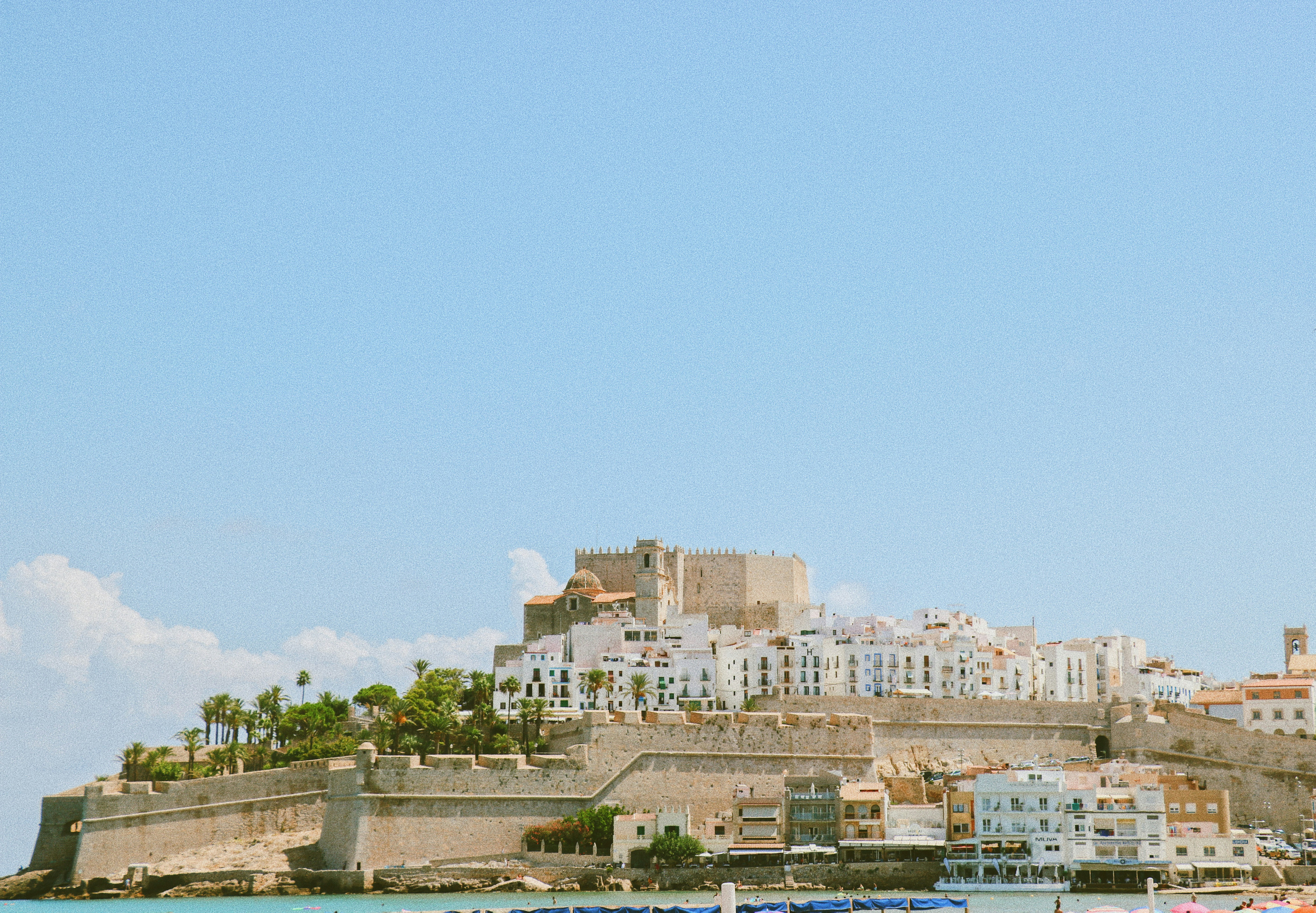 An illustrative photo of city buildings under blue sky.