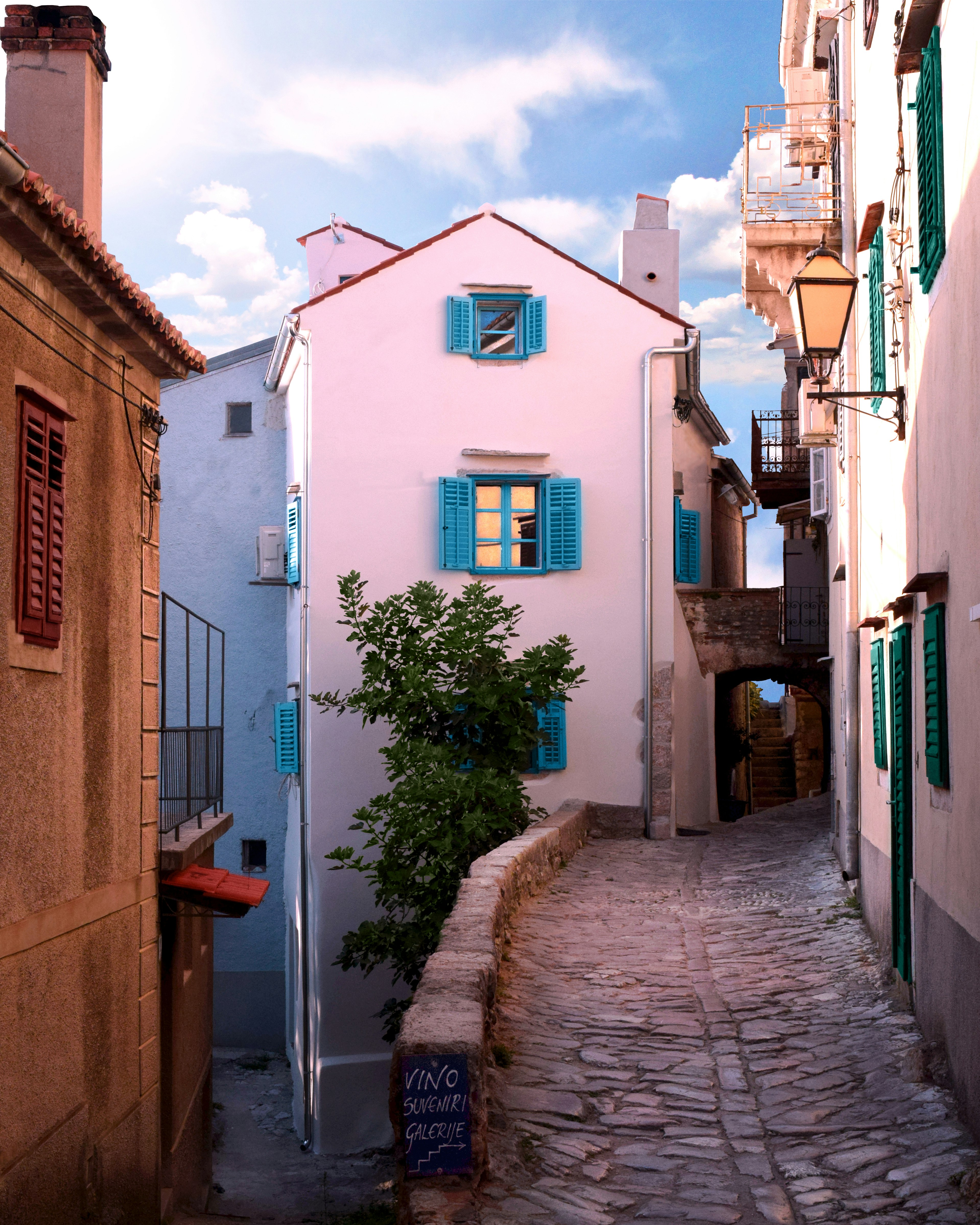 Photo by Unsplash An illustrative photo of a narrow street between white concrete houses
