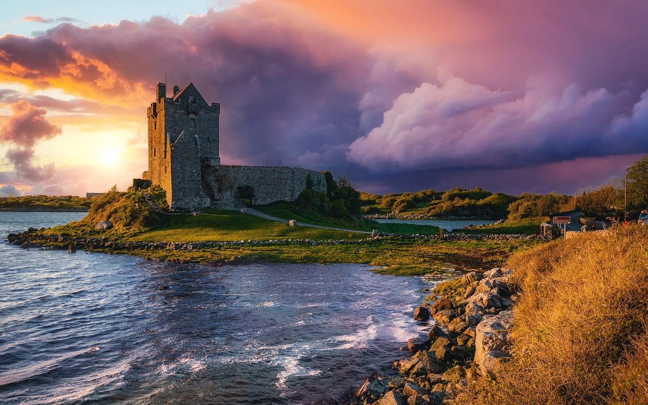 Photo by Pixabay An illustrative photo of a majestic stone castle perched on a grassy outcrop at the edge of sea