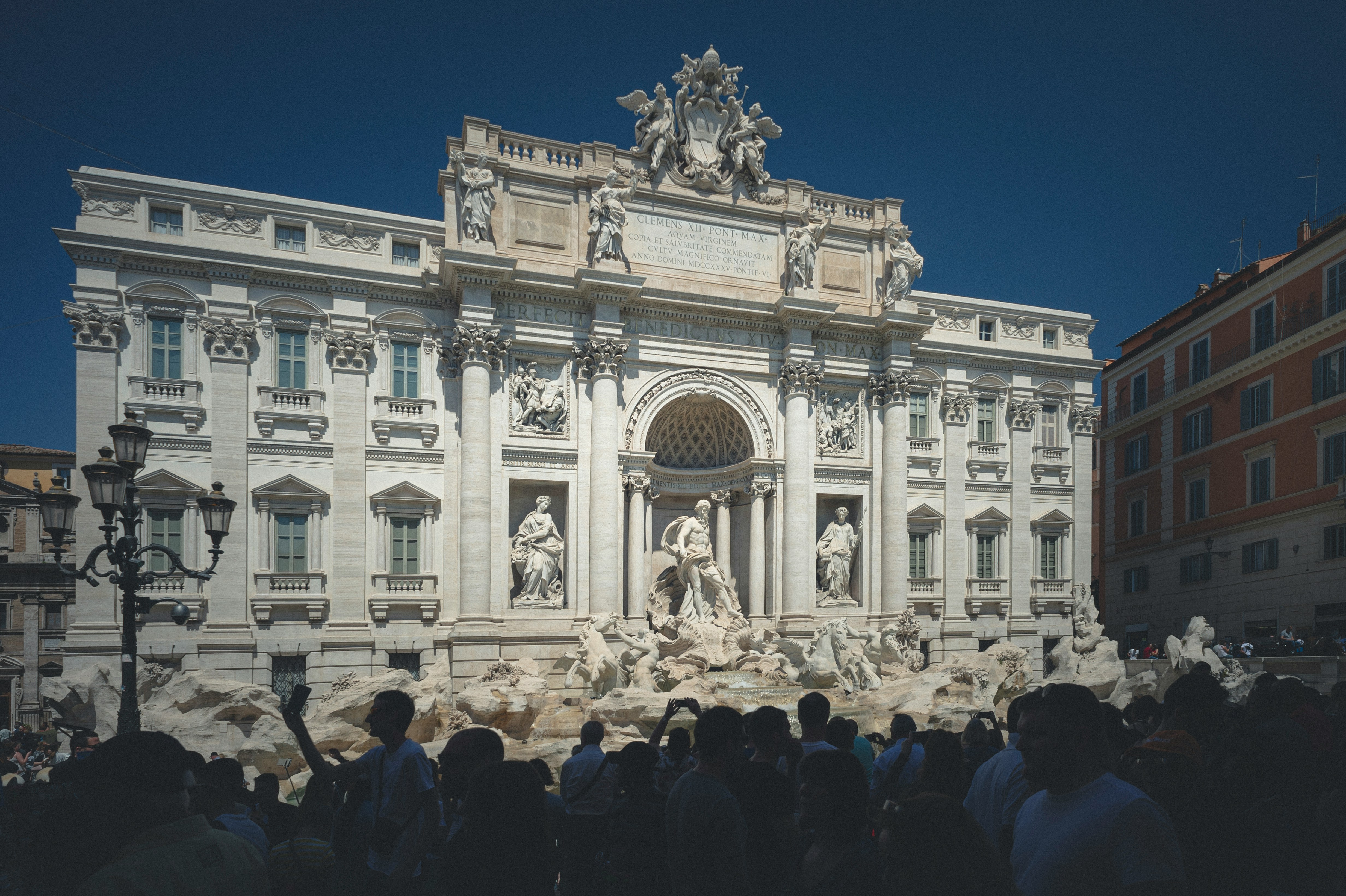 An illustrative photo of people standing in front of building.