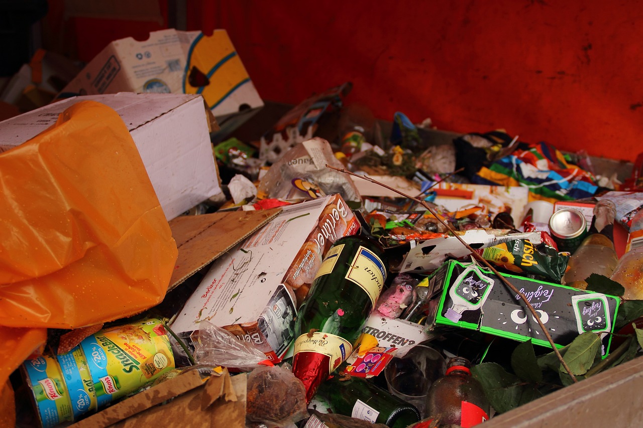 Photo by Pixabay An illustrative photo of a large pile of unsorted trash, including cardboard boxes, plastic containers, and glass bottles