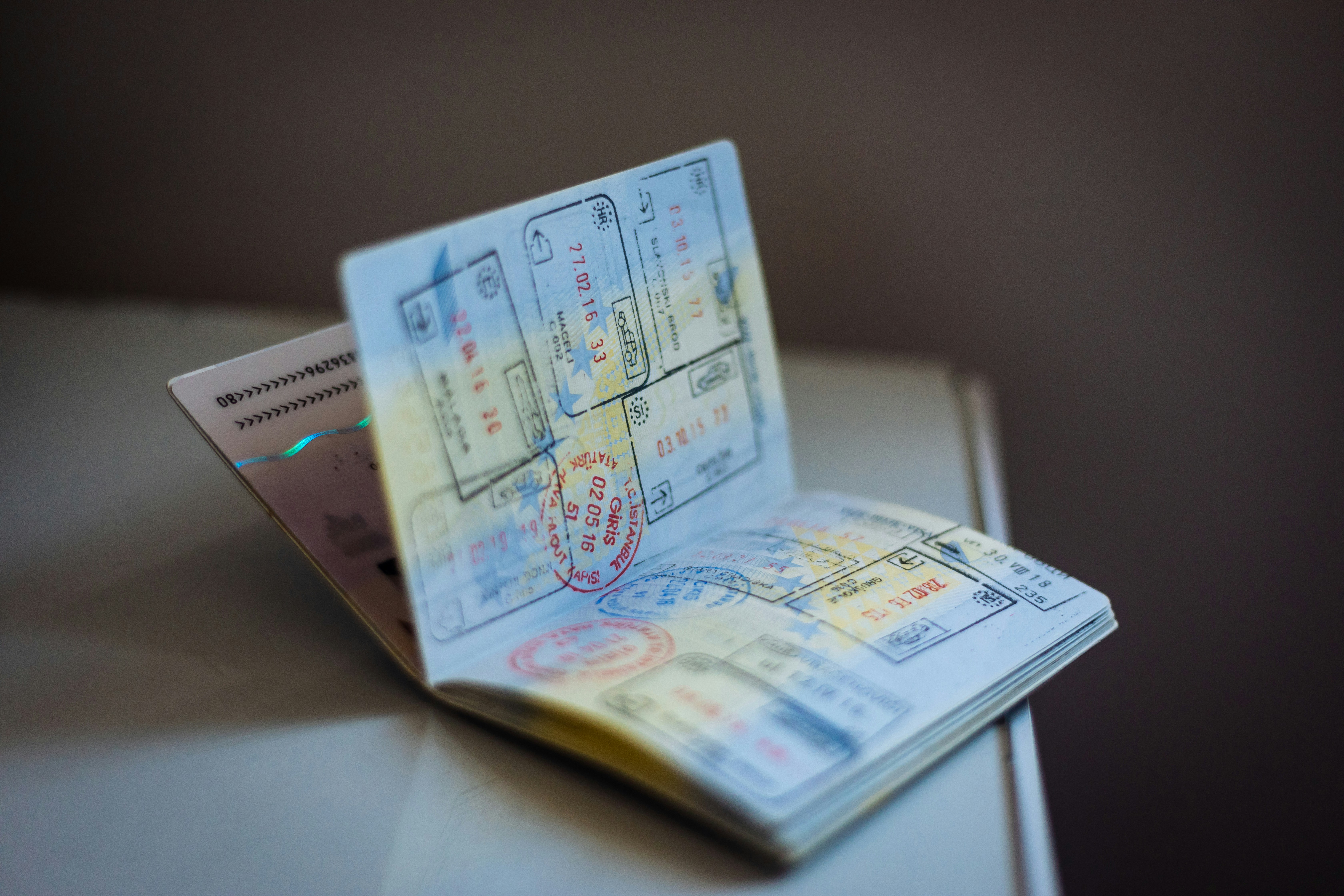 An illustrative photo of a passport with stamps on the table