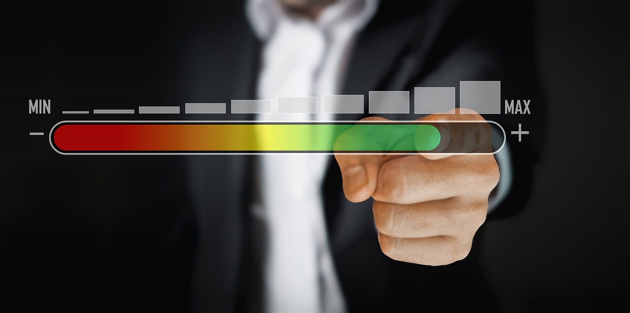 Photo by Pixabay An illustrative photo of a person in a business suit touching a virtual slider bar that transitions from red to green