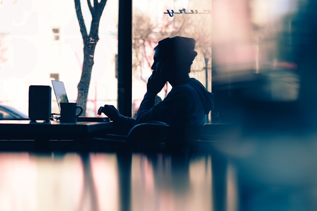 An illustrative photo of a person sits in front of a laptop.