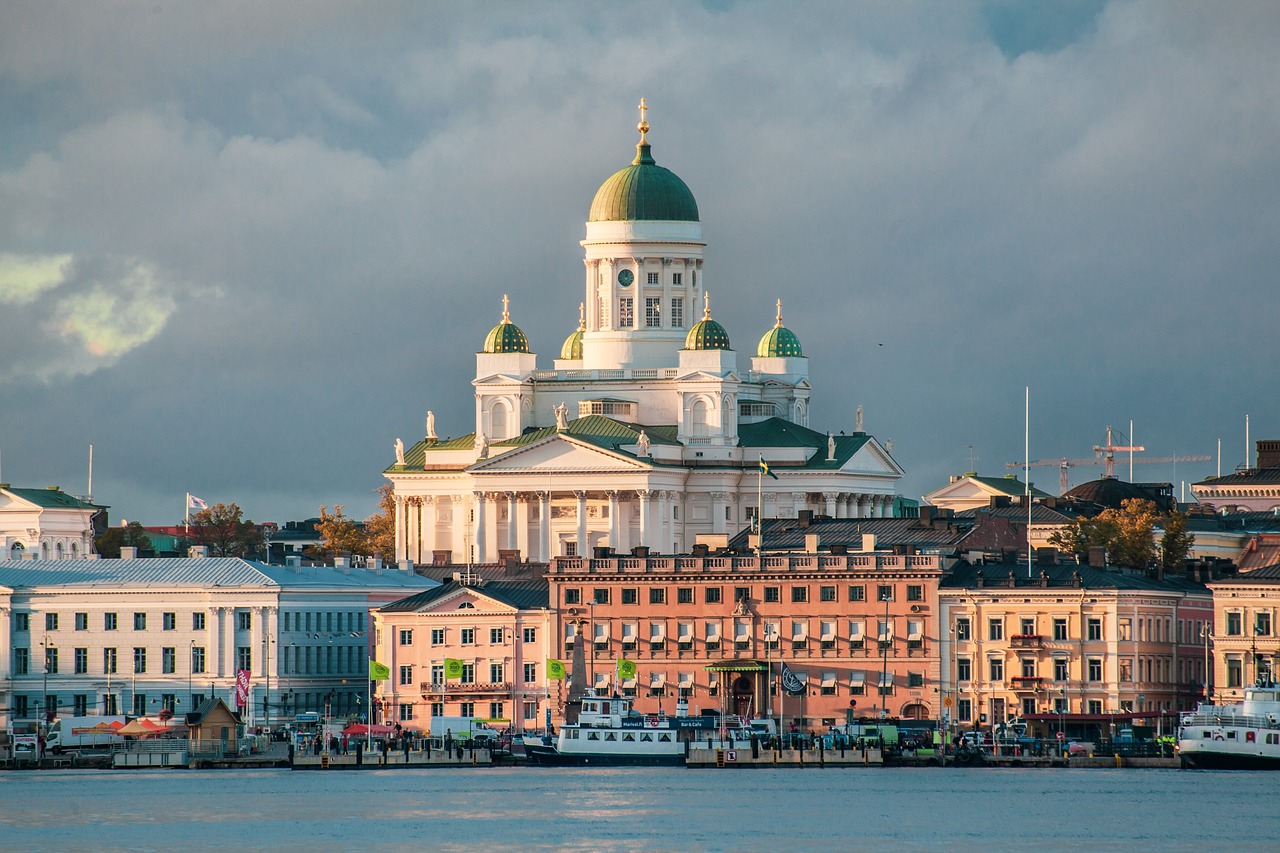 Photo by Pixabay An illustrative photo of the Helsinki Cathedral with its green domes, set against a backdrop of colorful buildings
