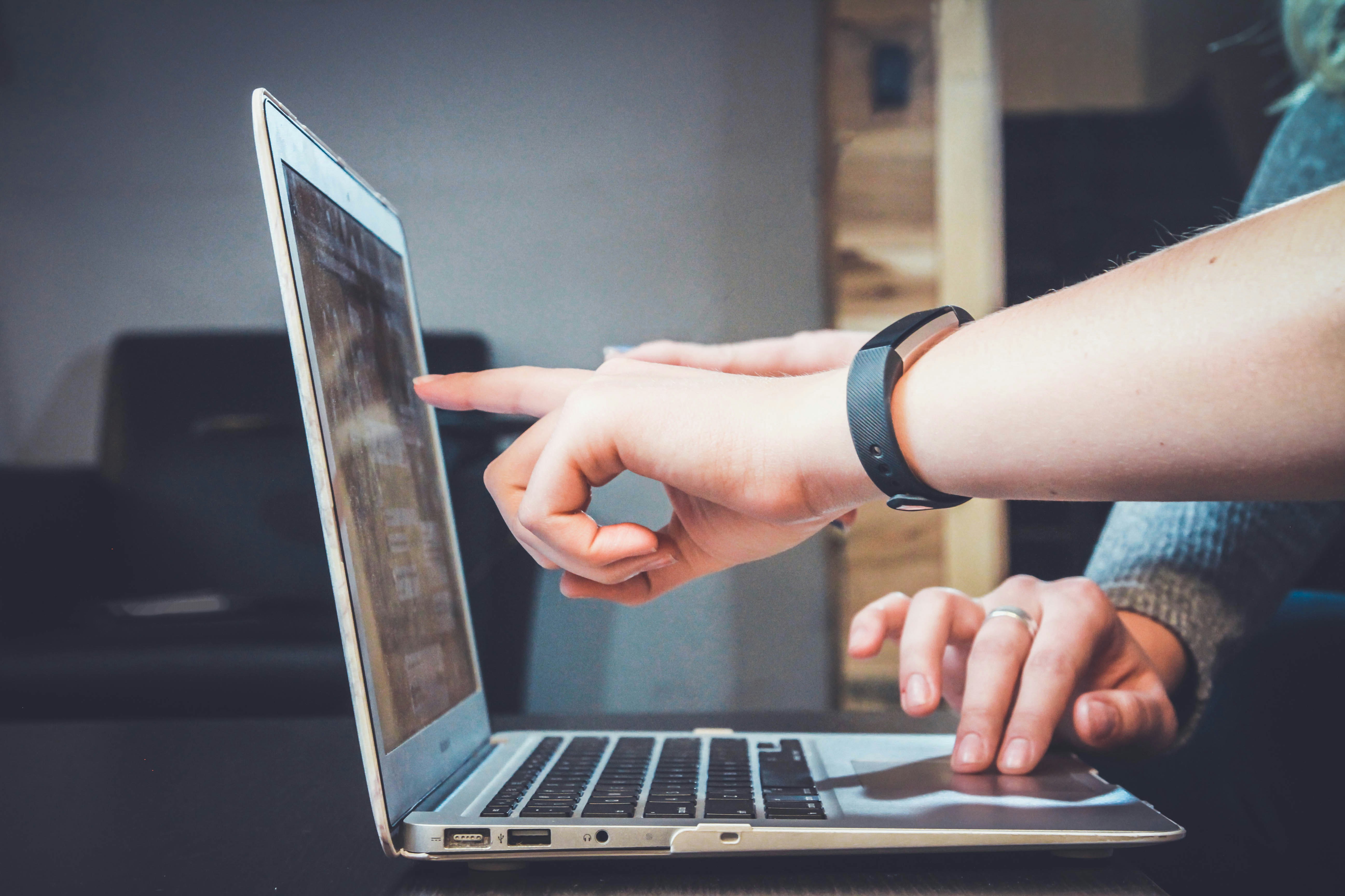 An illustrative photo of person using a laptop.