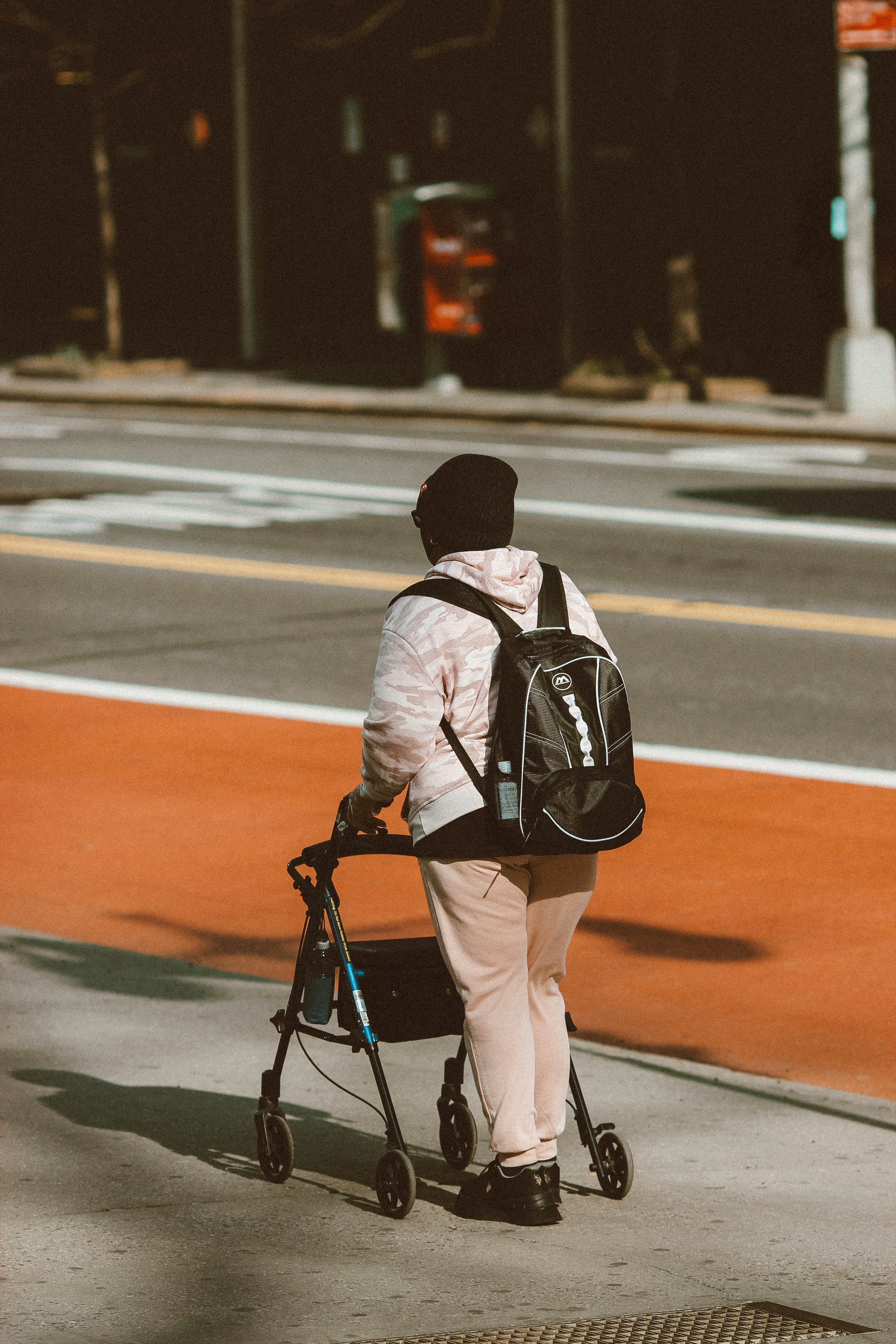 An illustrative photo of an individual using a four-wheeled walker