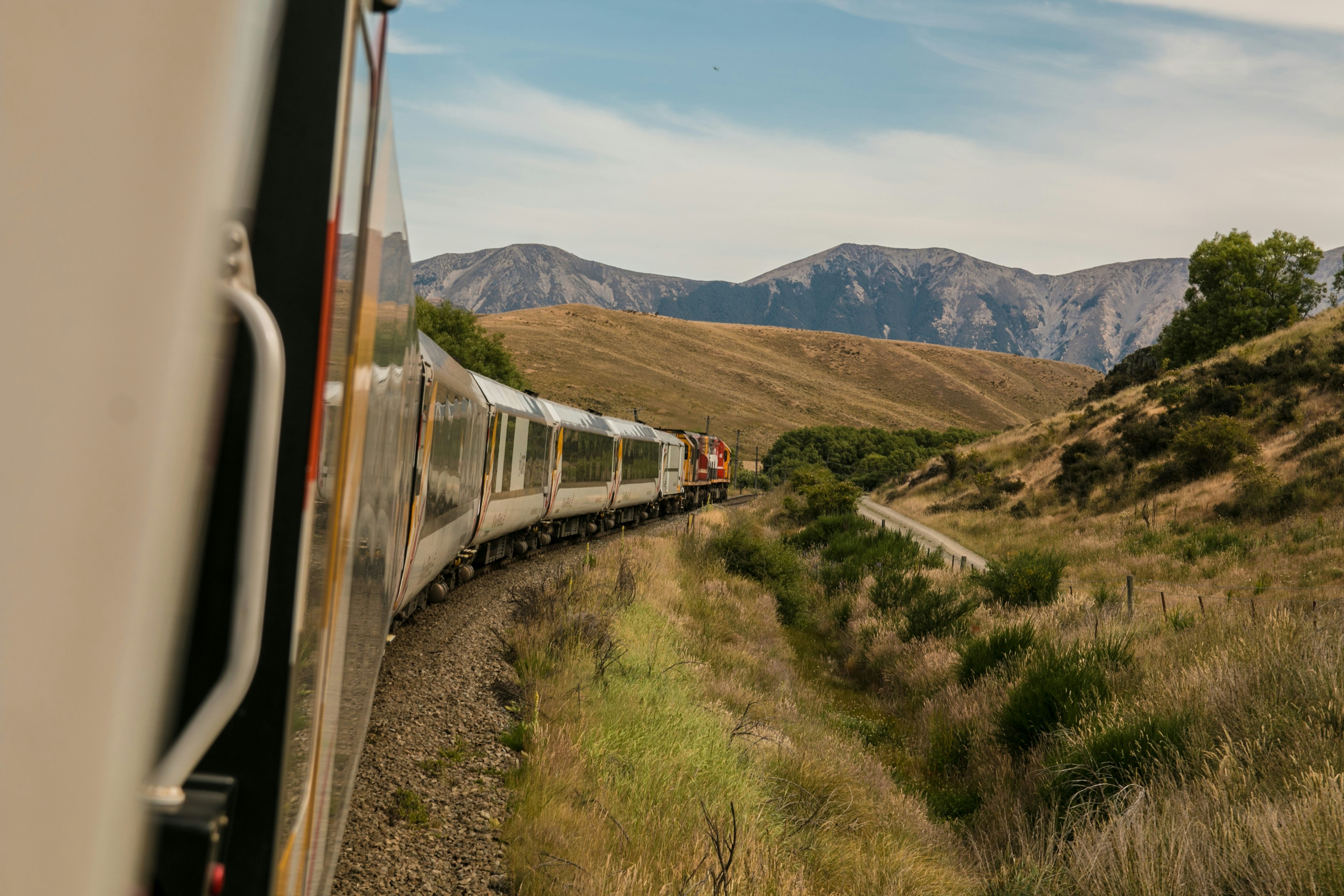 An illustrative photo of a train with the distance of mountain.