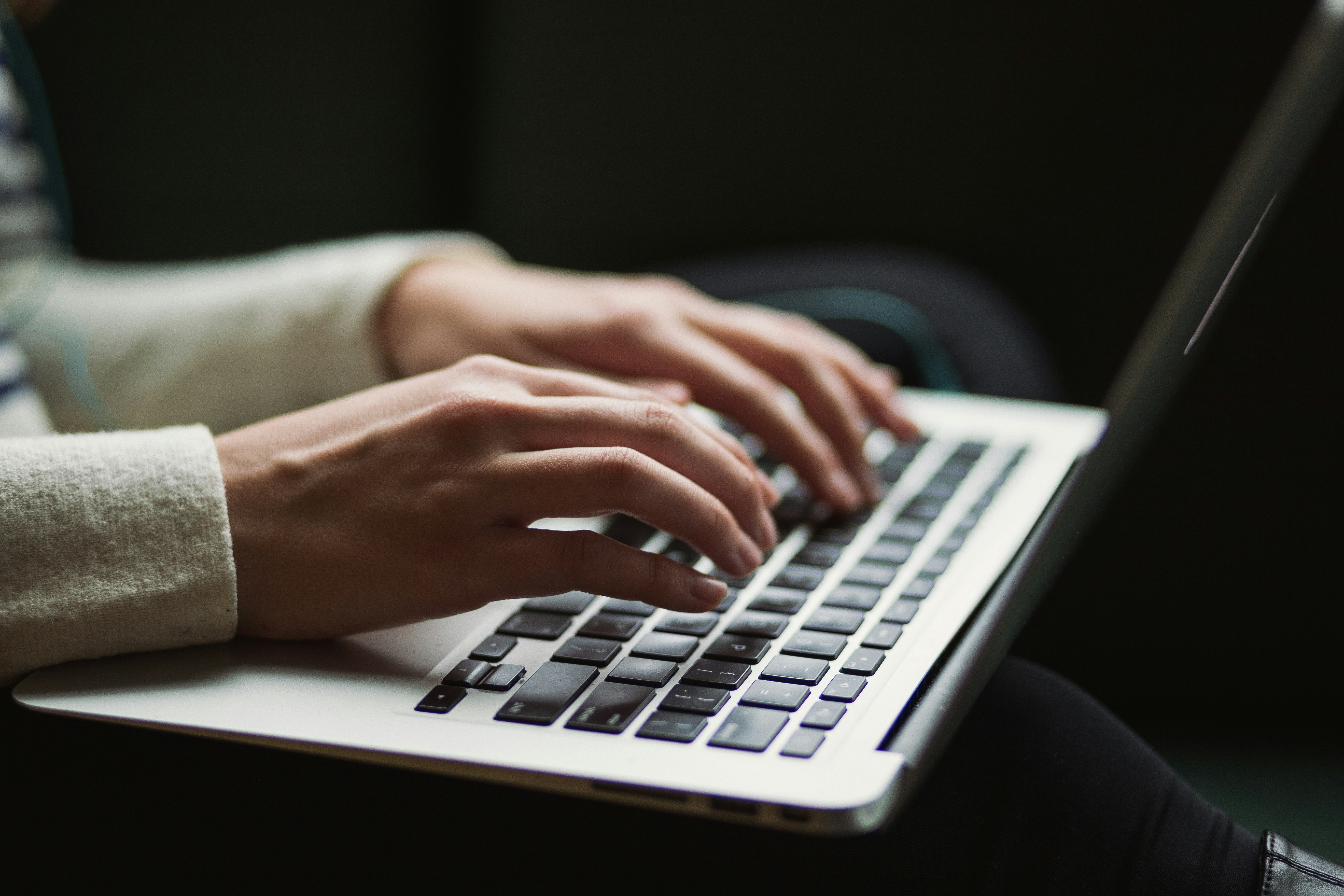 An illustrative photo of a person using a laptop