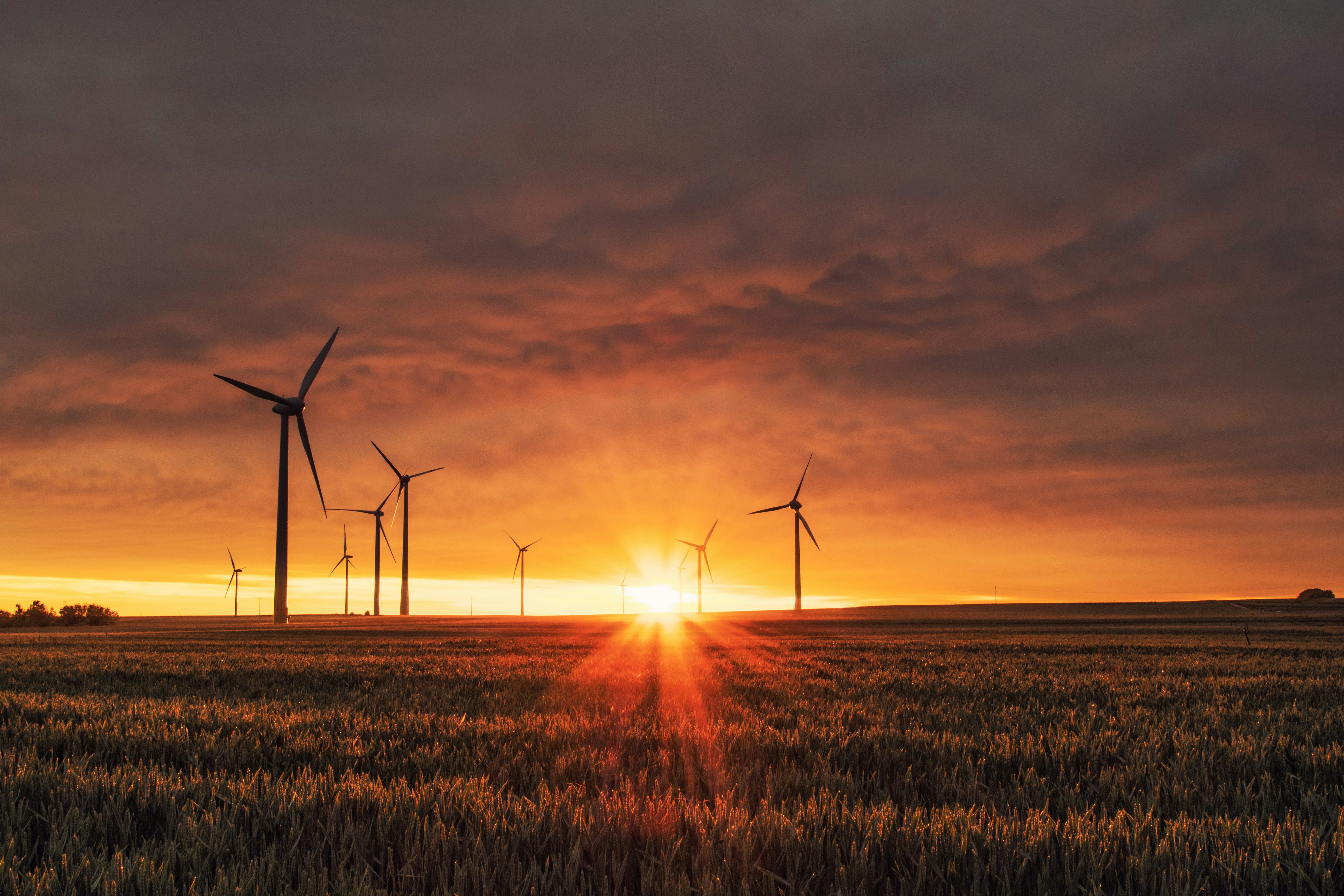 An illustrative photo of a windmill on grass field during golden hour