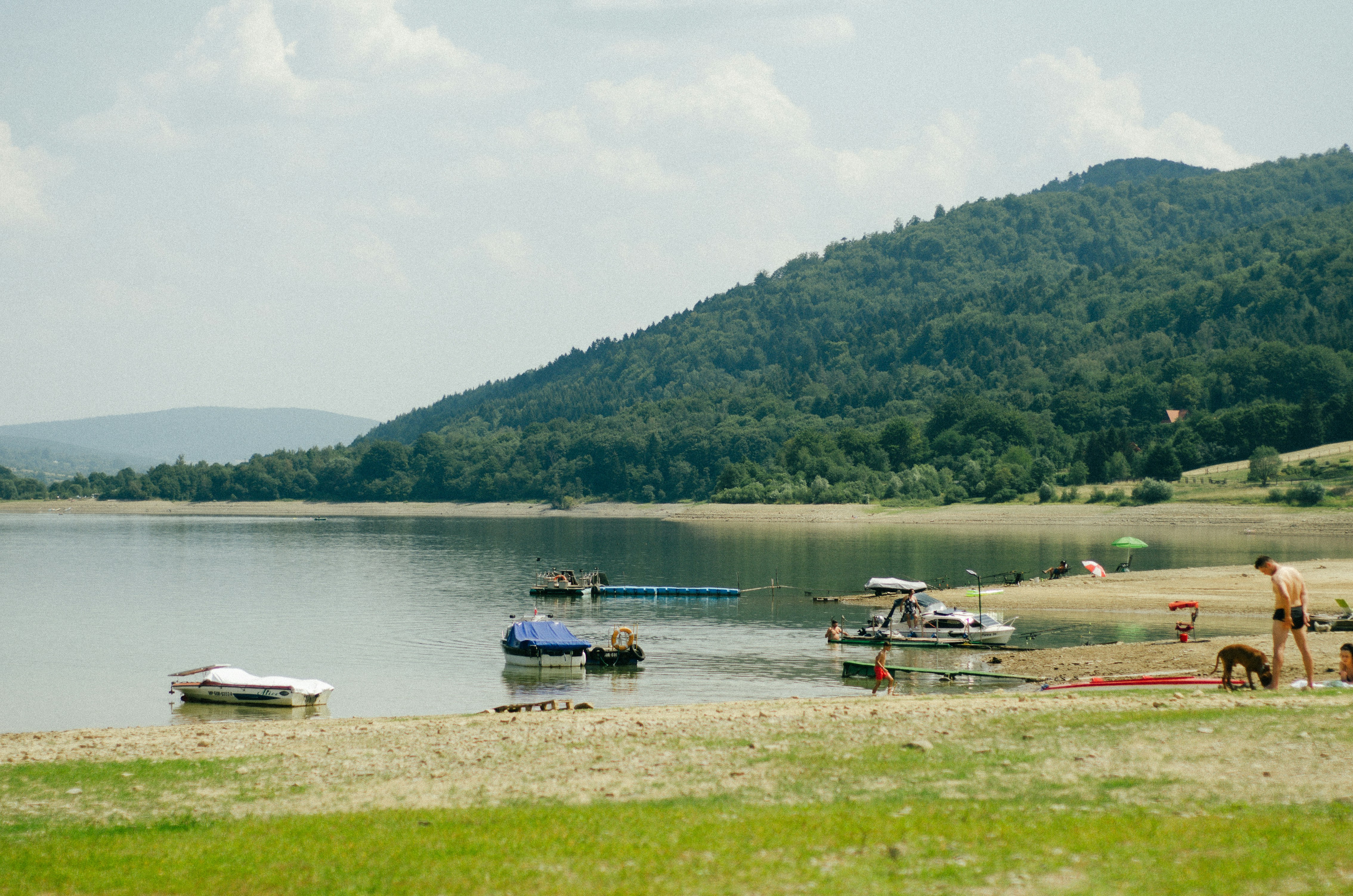 An illustrative photo of a group of boats sitting on top of a lake.