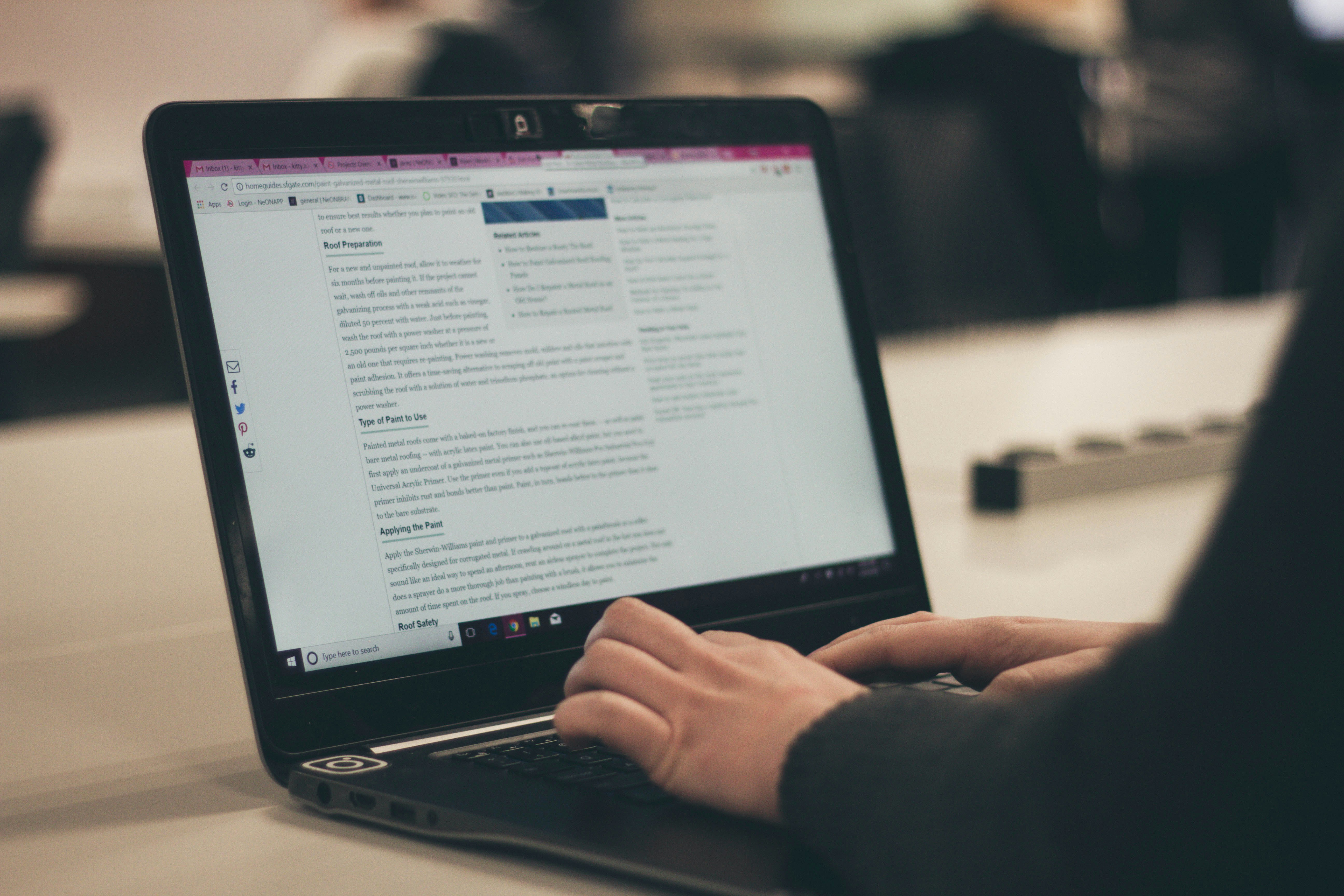 An illustrative photo of a person typing on a laptop computer