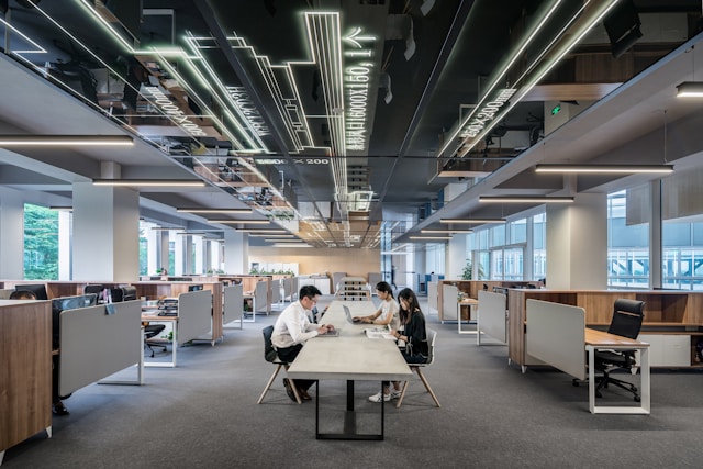 An illustrative photo of a man and woman sitting across from each other at a table in an office