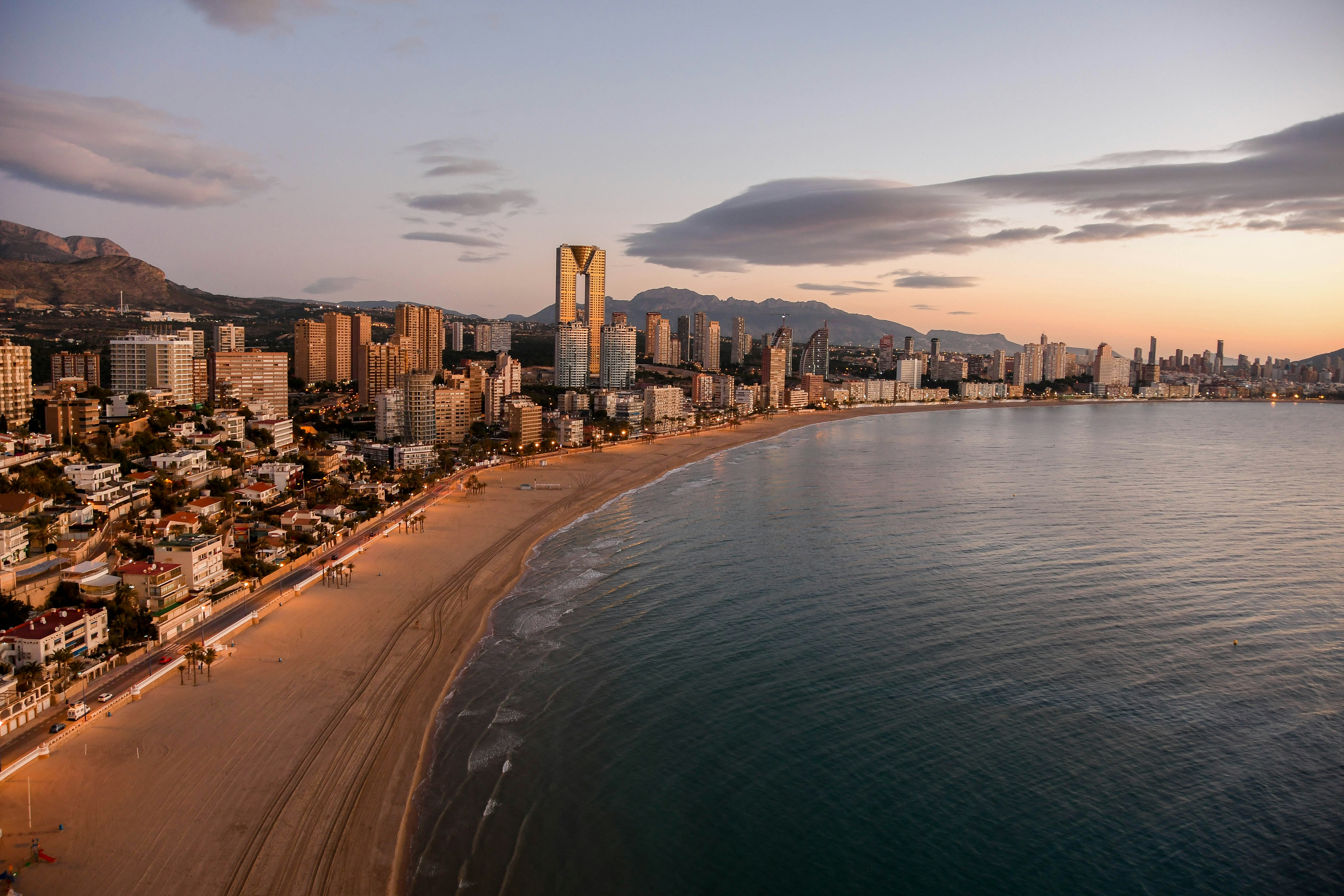 An illustrative photo of city skyline near body of water.