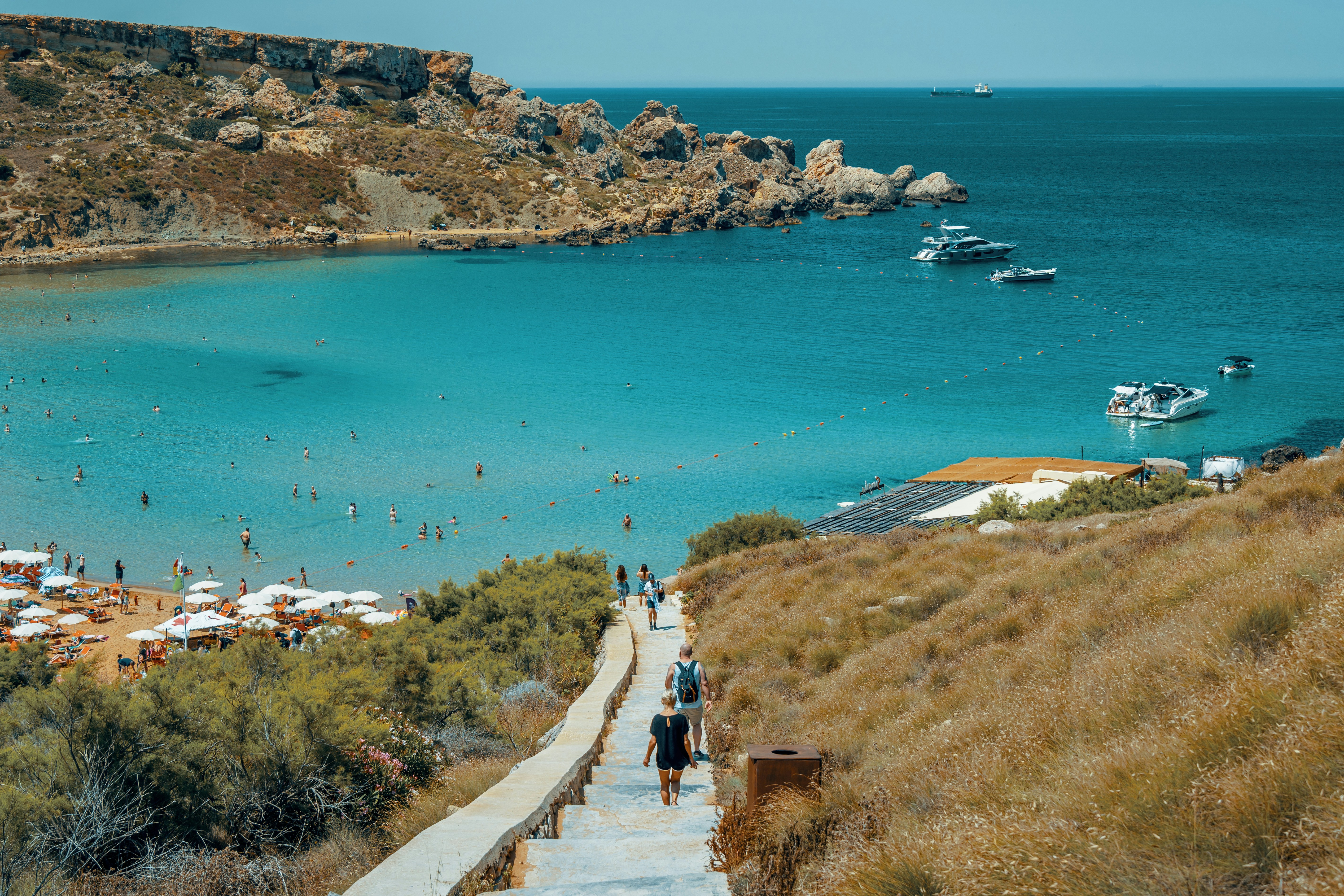 An illustrative photo of a coastal scene with a clear blue sea.