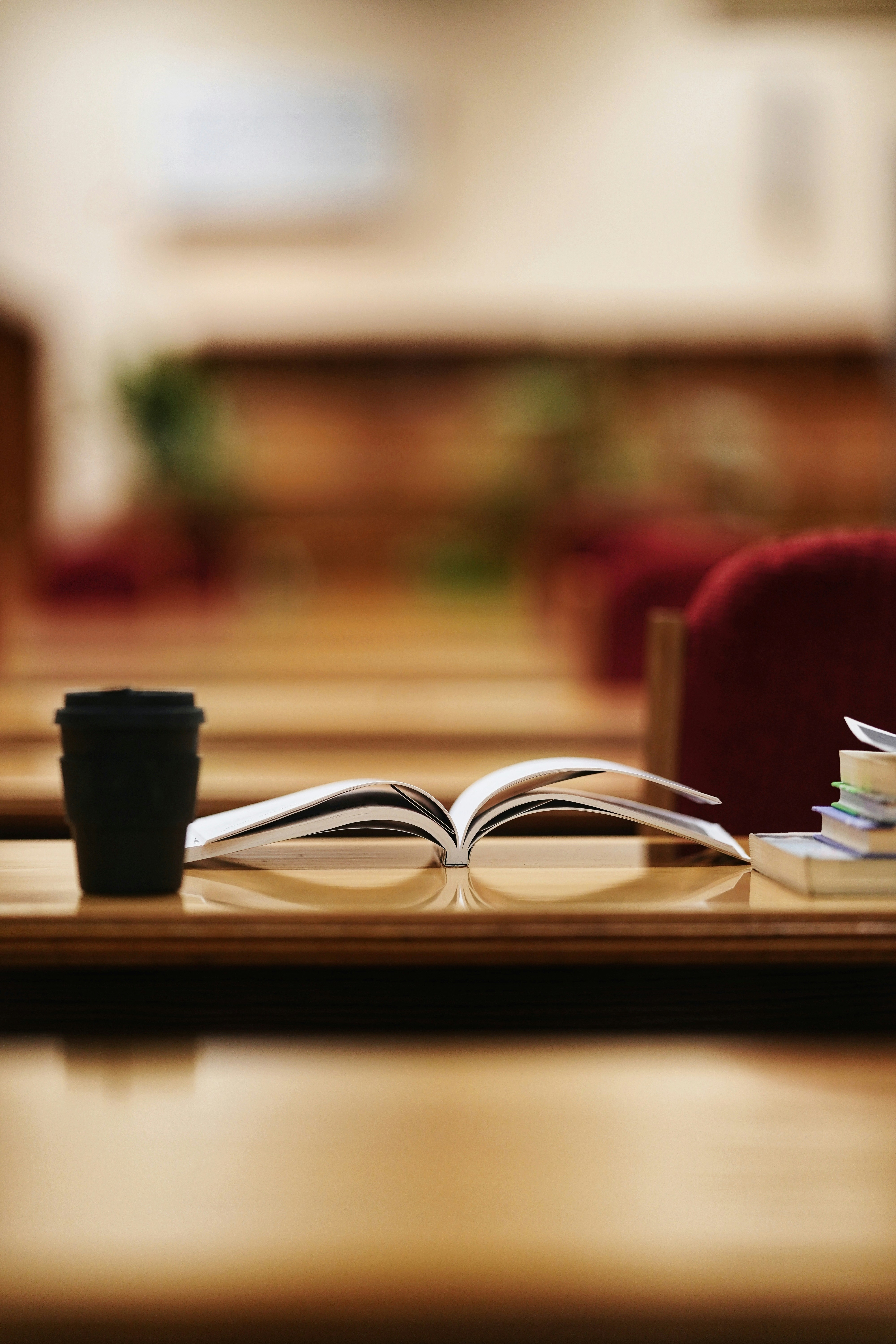 An illustrative photo of an opened book on a wooden brown table