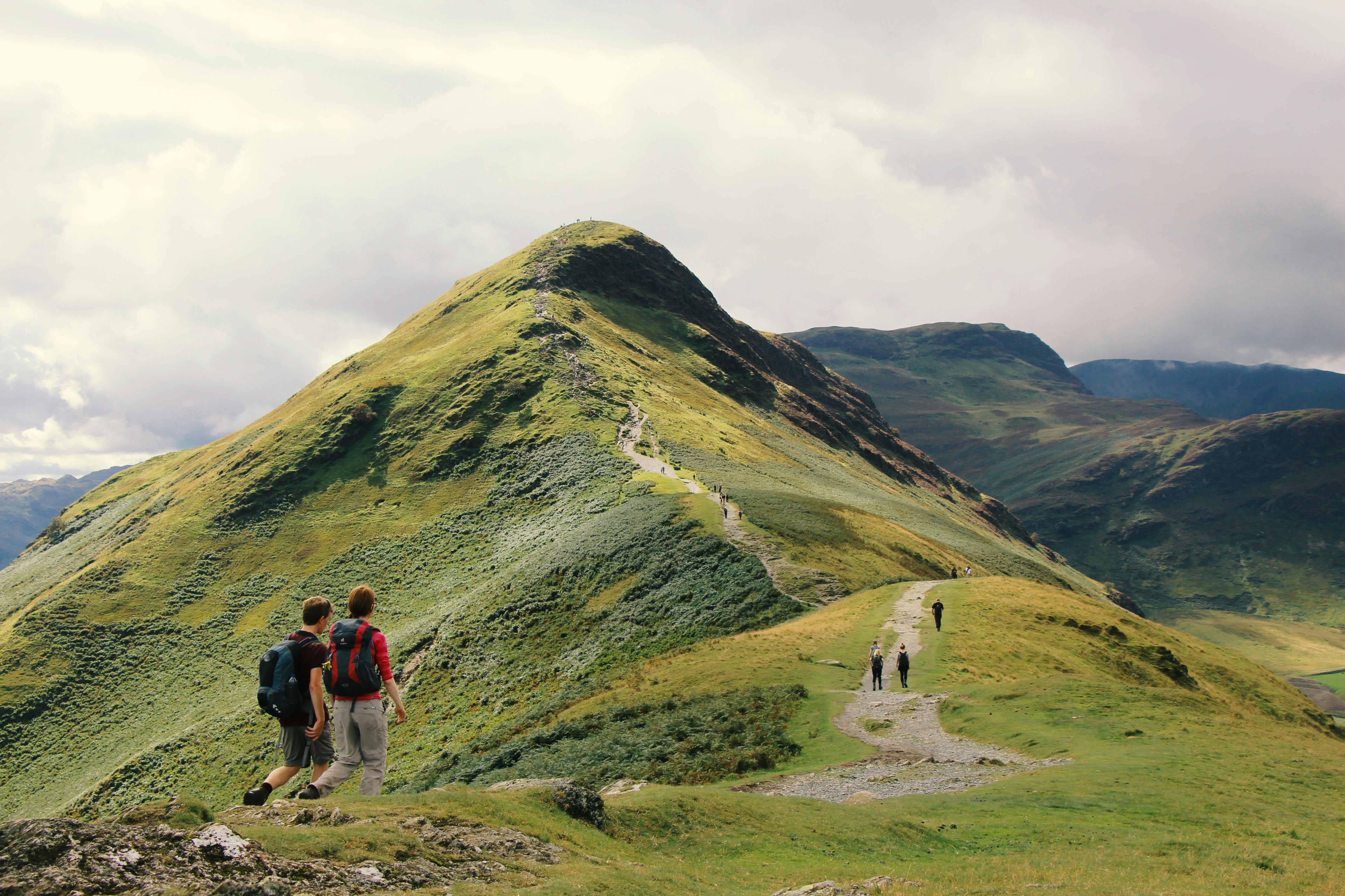 An illustrative photo of people standing on top of a mountain