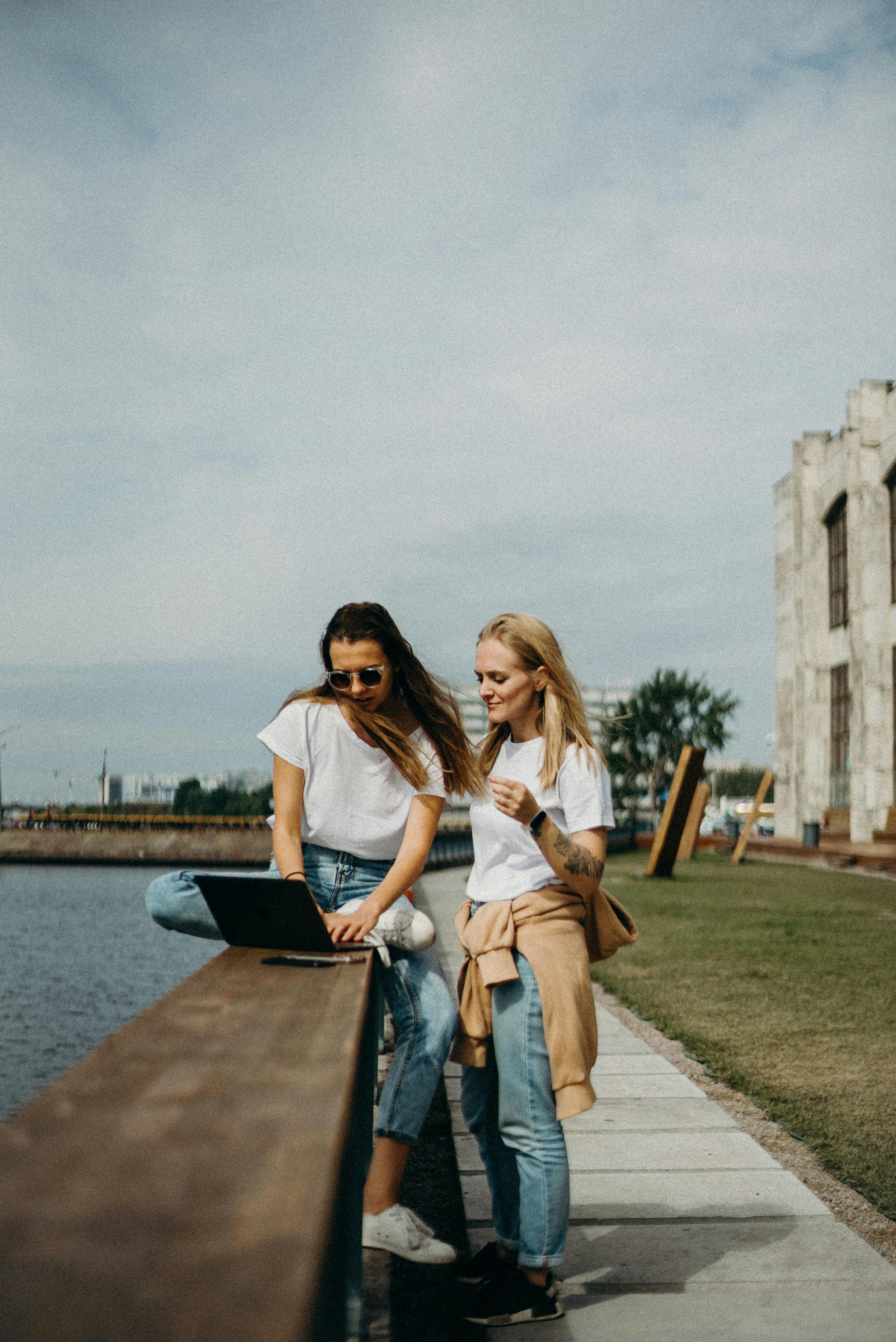 An illustrative photo of two women sitting near beach