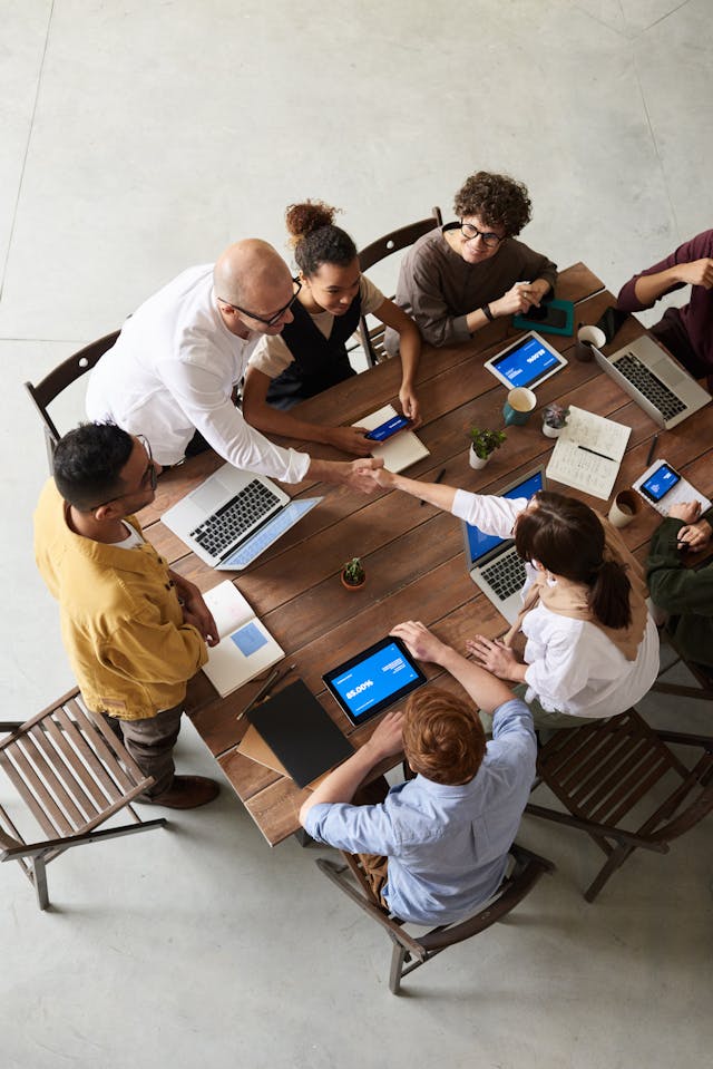 An illustrative photo of a group of professionals engaged in a collaborative discussion