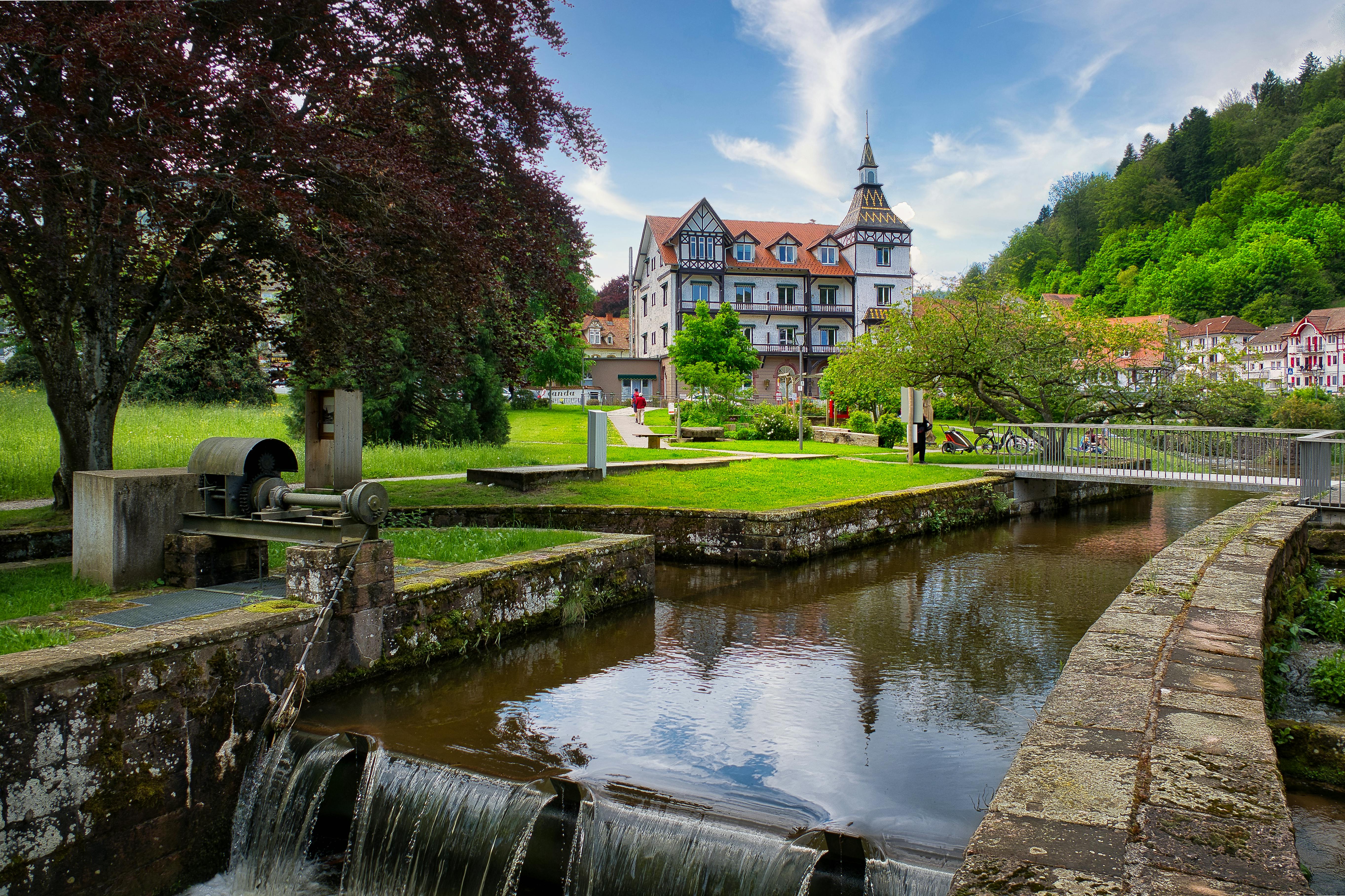 Photo by Pexels An illustrative photo of a picturesque outdoor scene featuring a small water canal with a waterfall in the foreground.