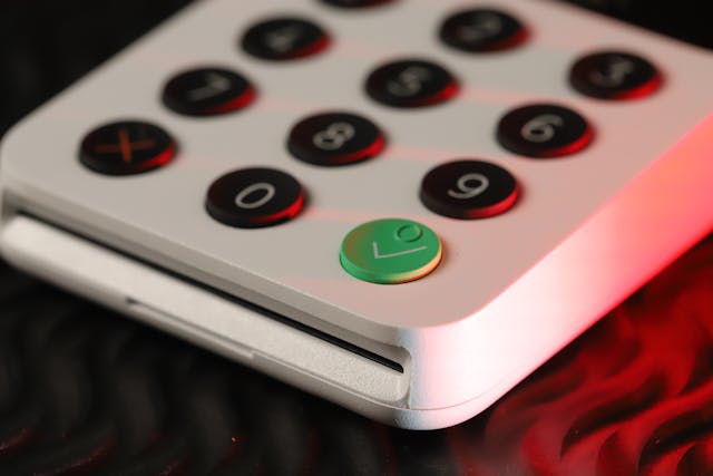 An illustrative photo of a close-up of a white keypad with black and green buttons