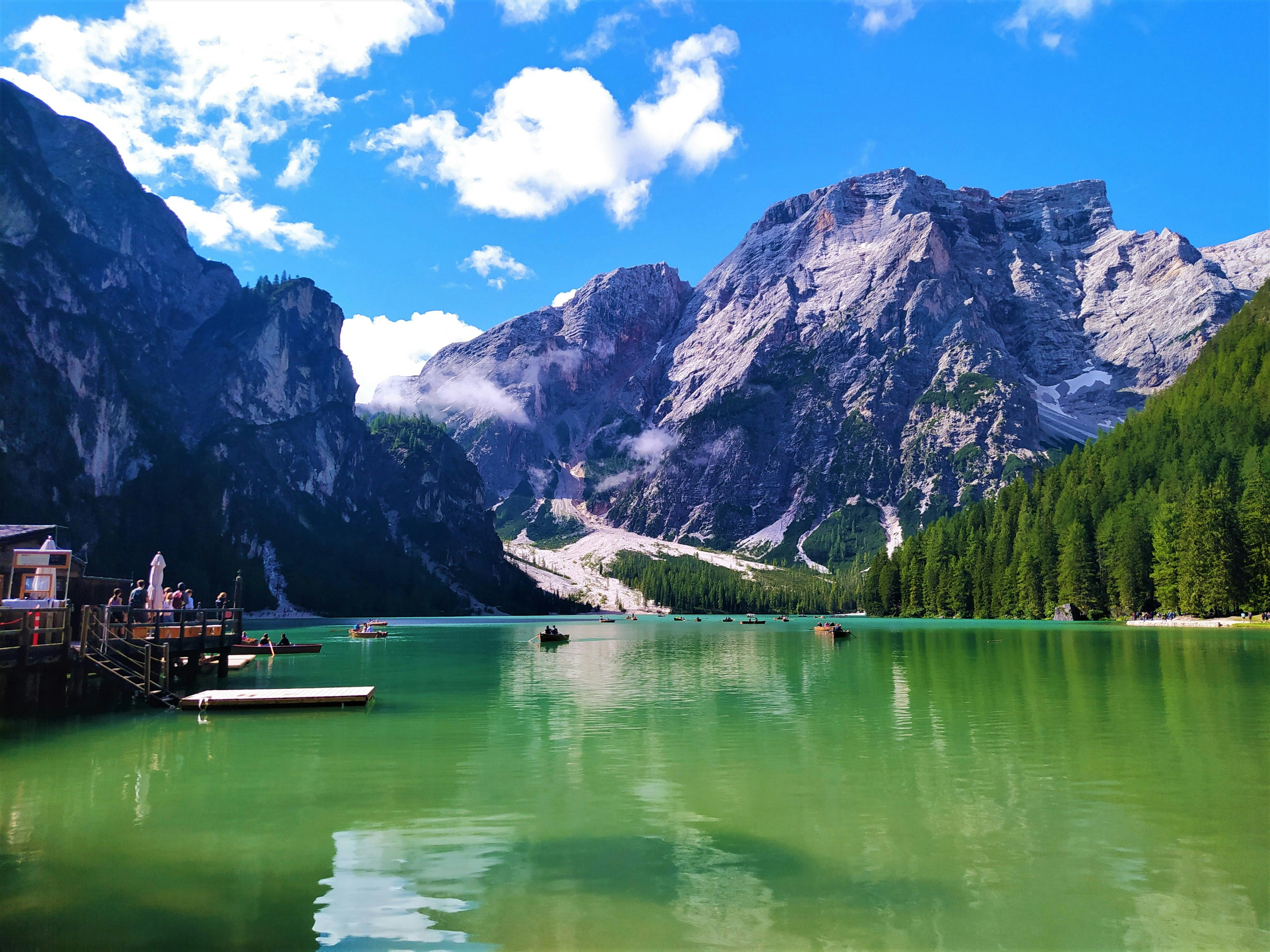 An illustrative photo of a green lake near mountains