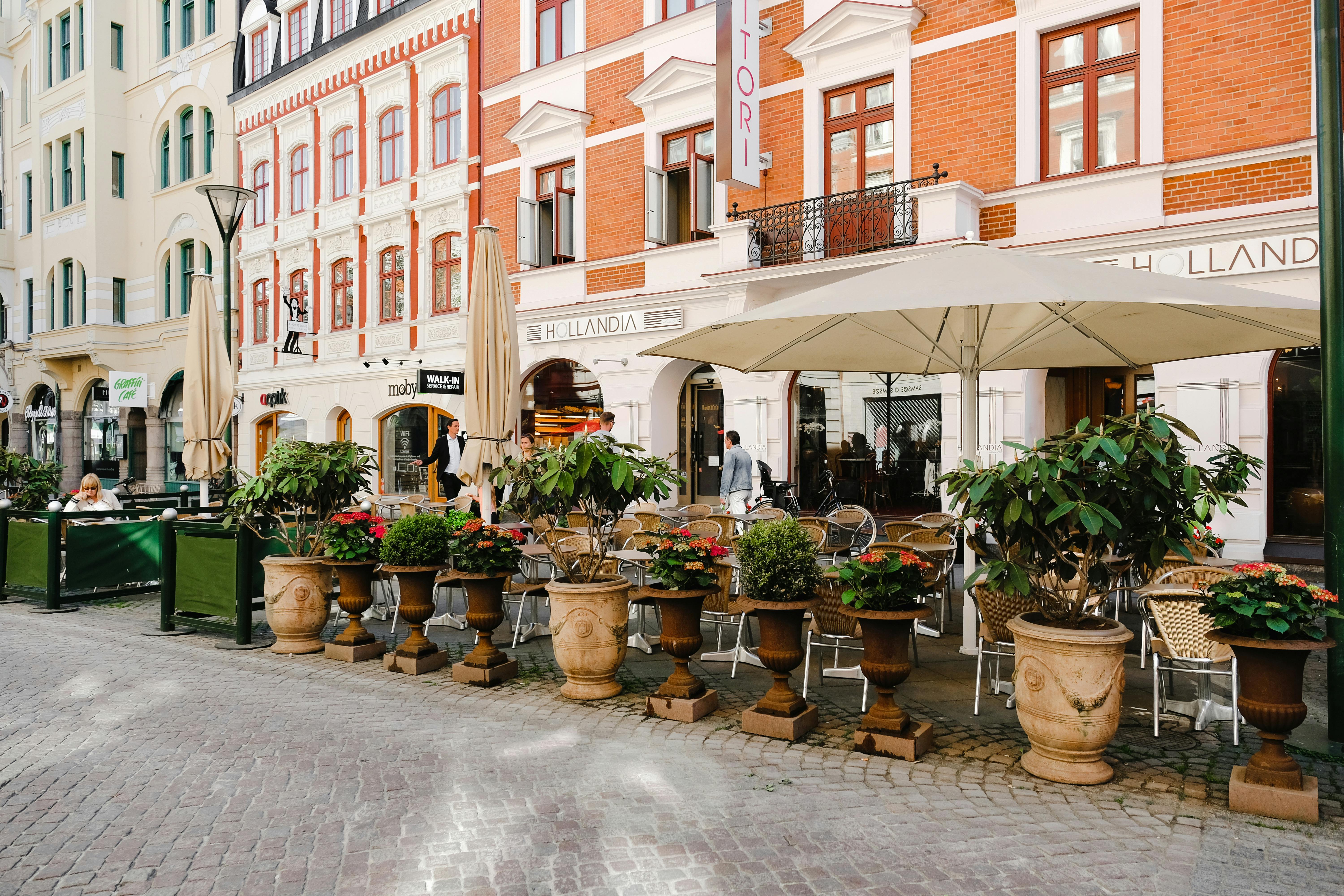 Photo by Pexels An illustrative photo of an outdoor seating area of a café on a cobblestone street.
